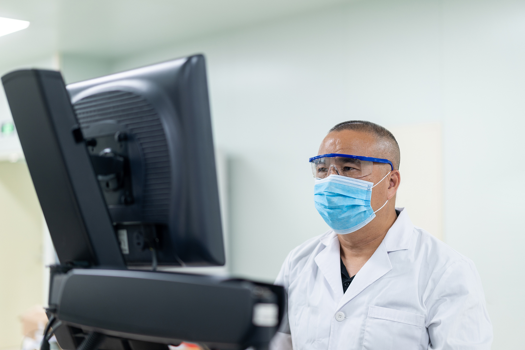 doctor working in testing laboratory in hospital  with face mask