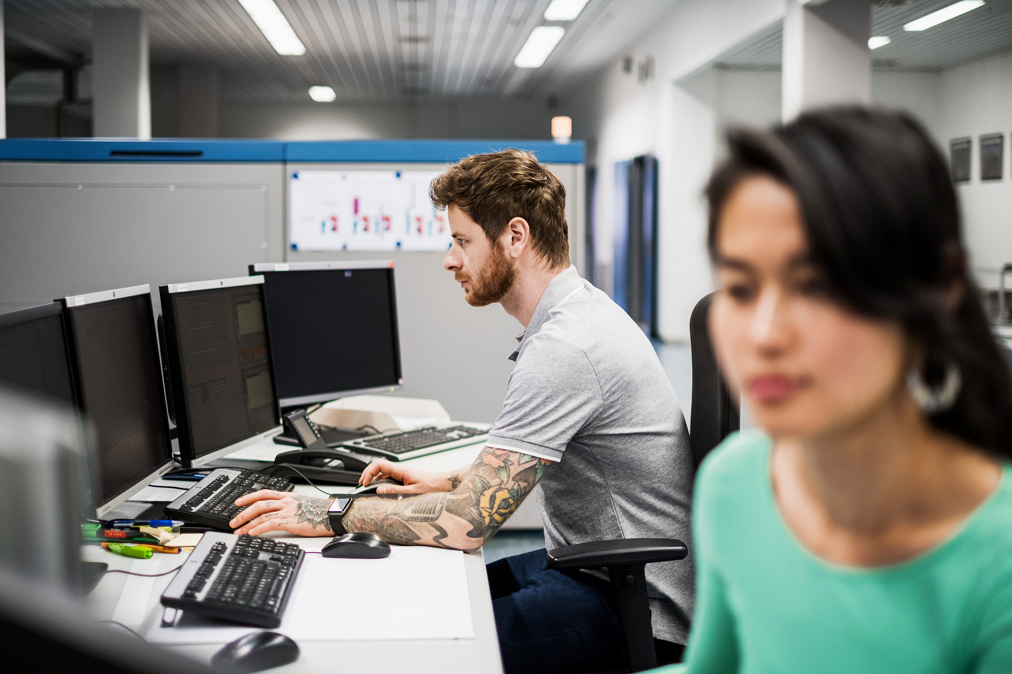 man working on computer in printery office