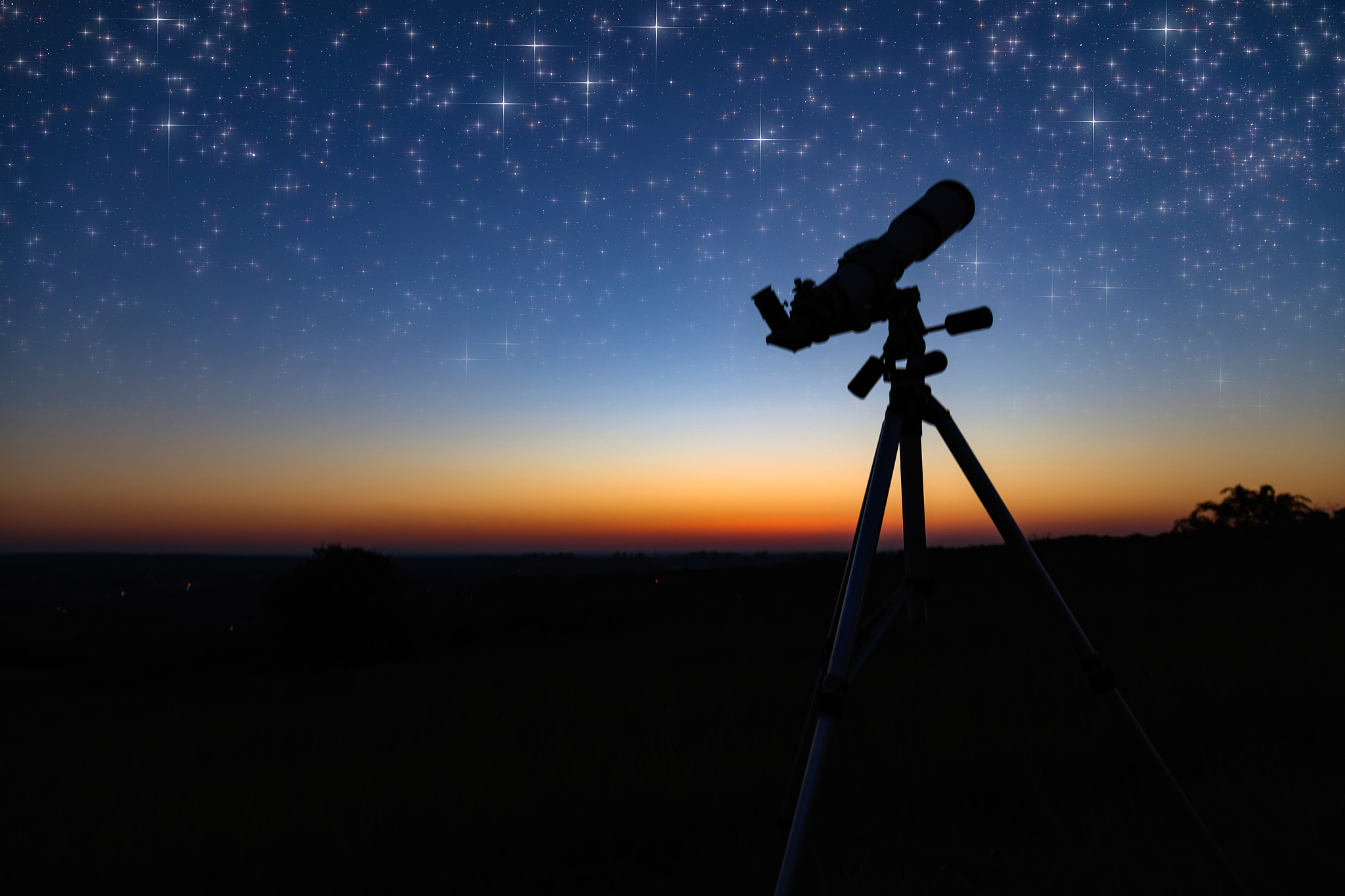 silhouette of a astronomy telescope with twilight sky.