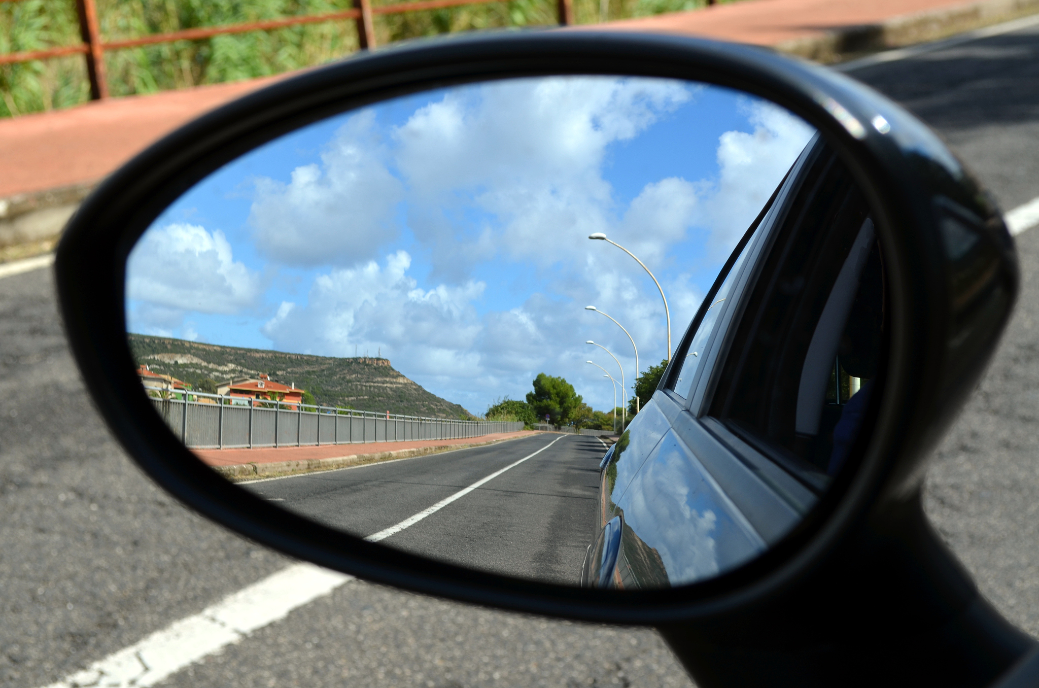 looking in the car mirror at sardinia island italy