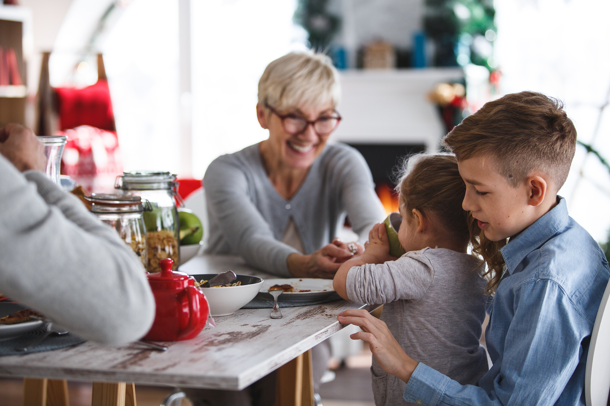 grandmother enjoying breakfast with her grandchildren