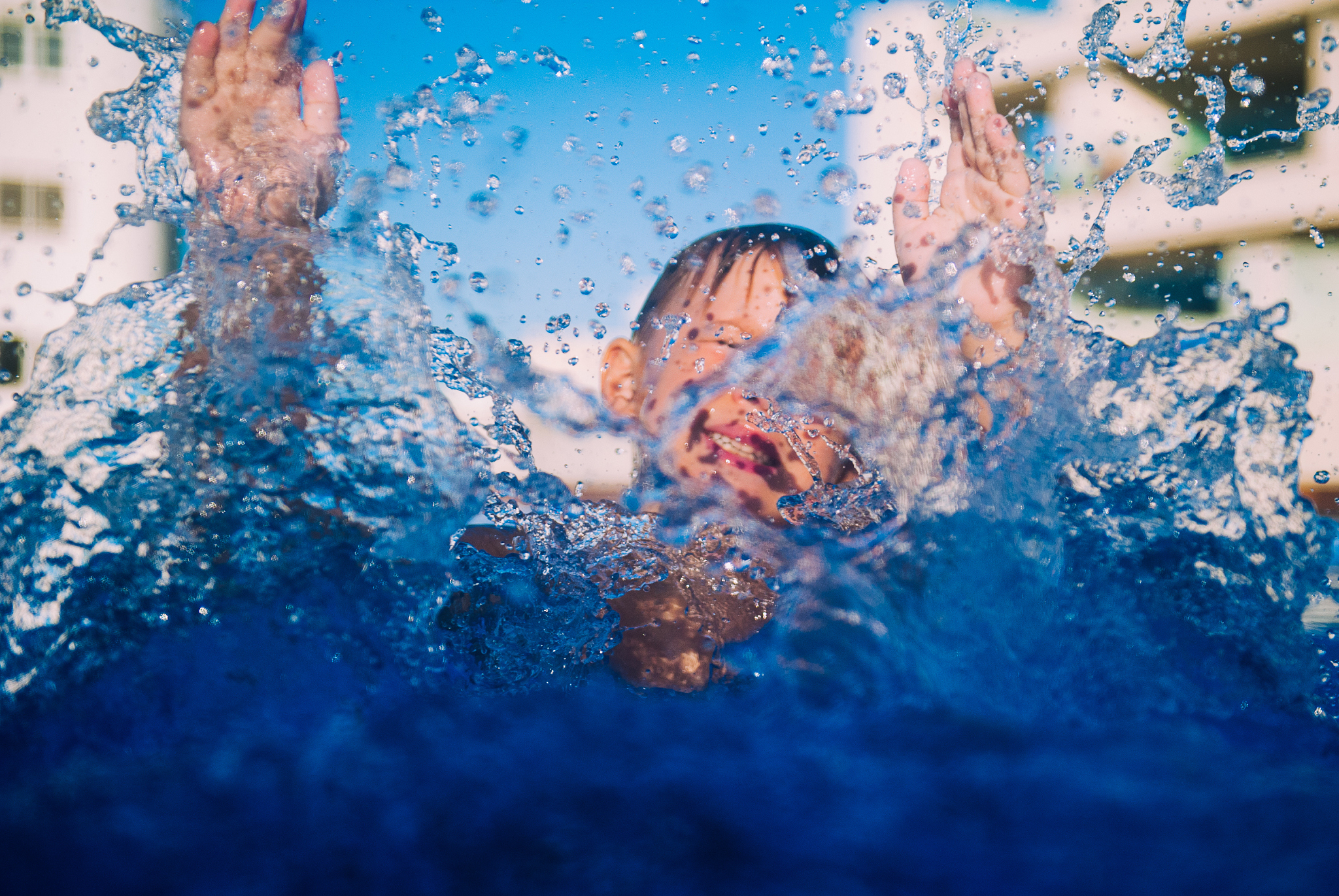 kid diving at pool