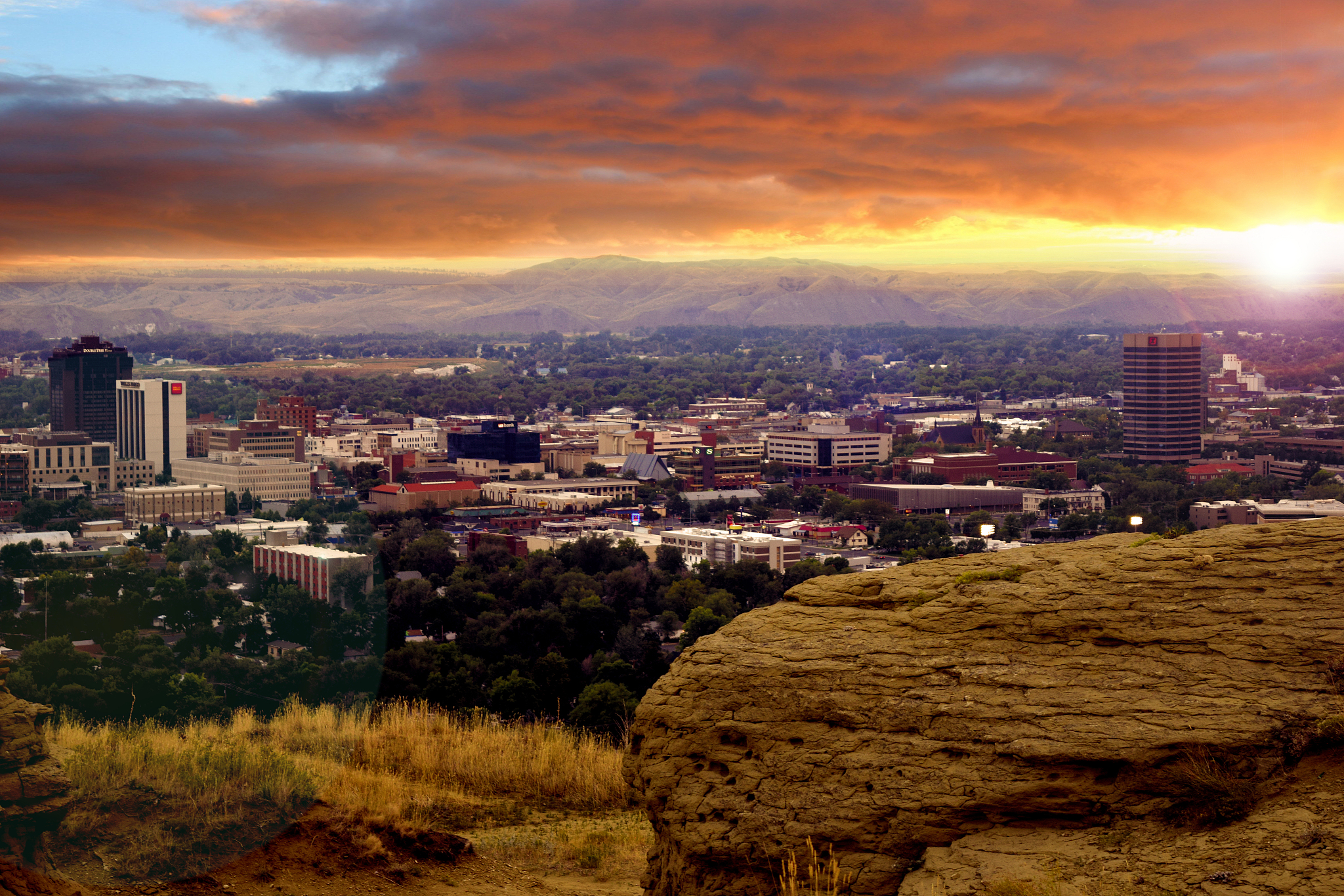 cityscape against cloudy sky during sunset