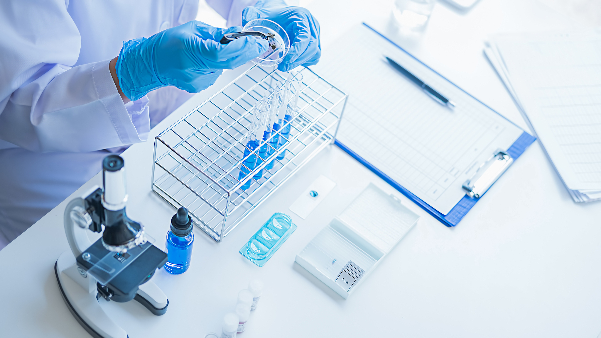 medical or scientific researcher or man doctor looking at a test