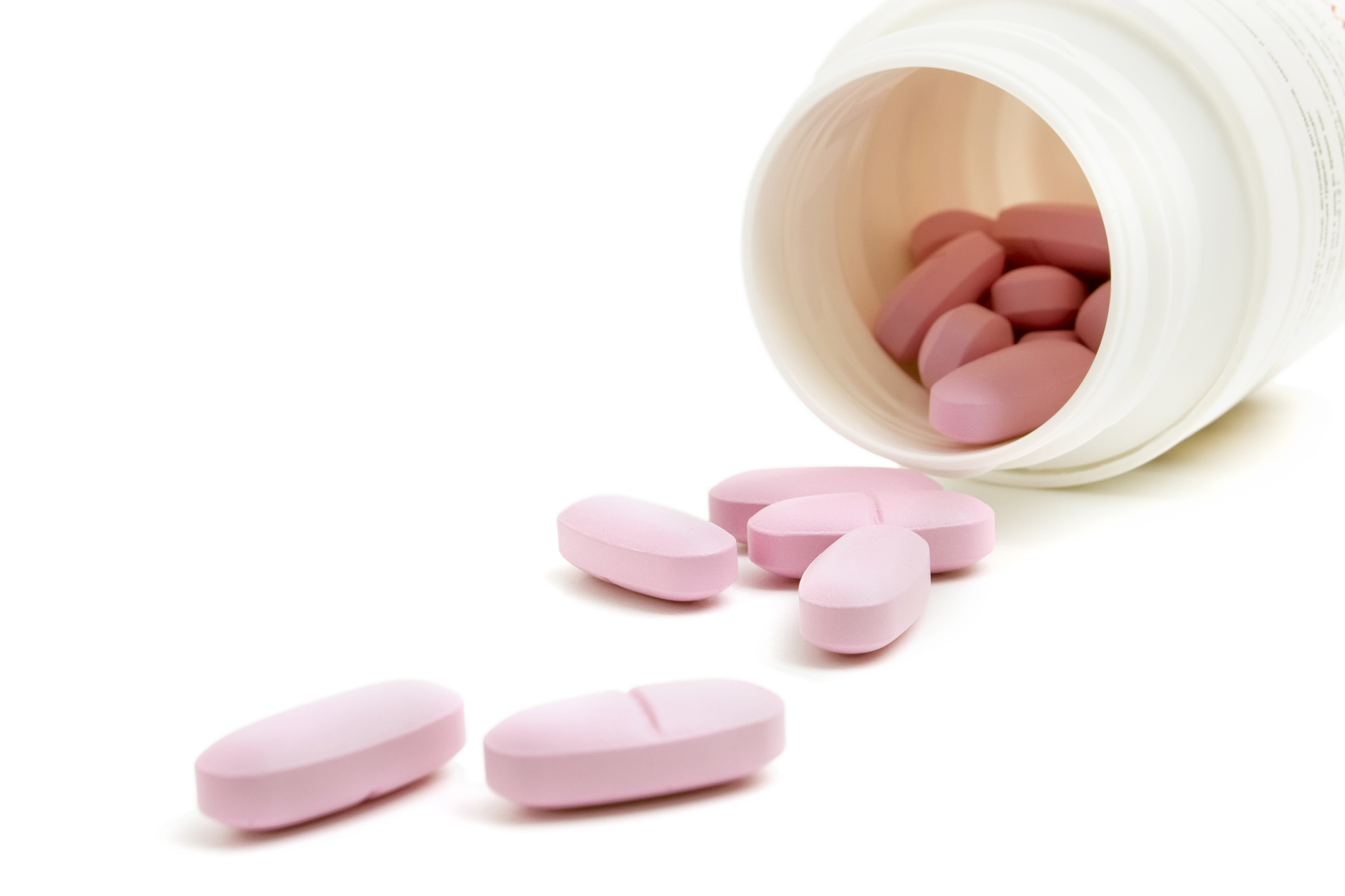 plastic bottle and pink pills