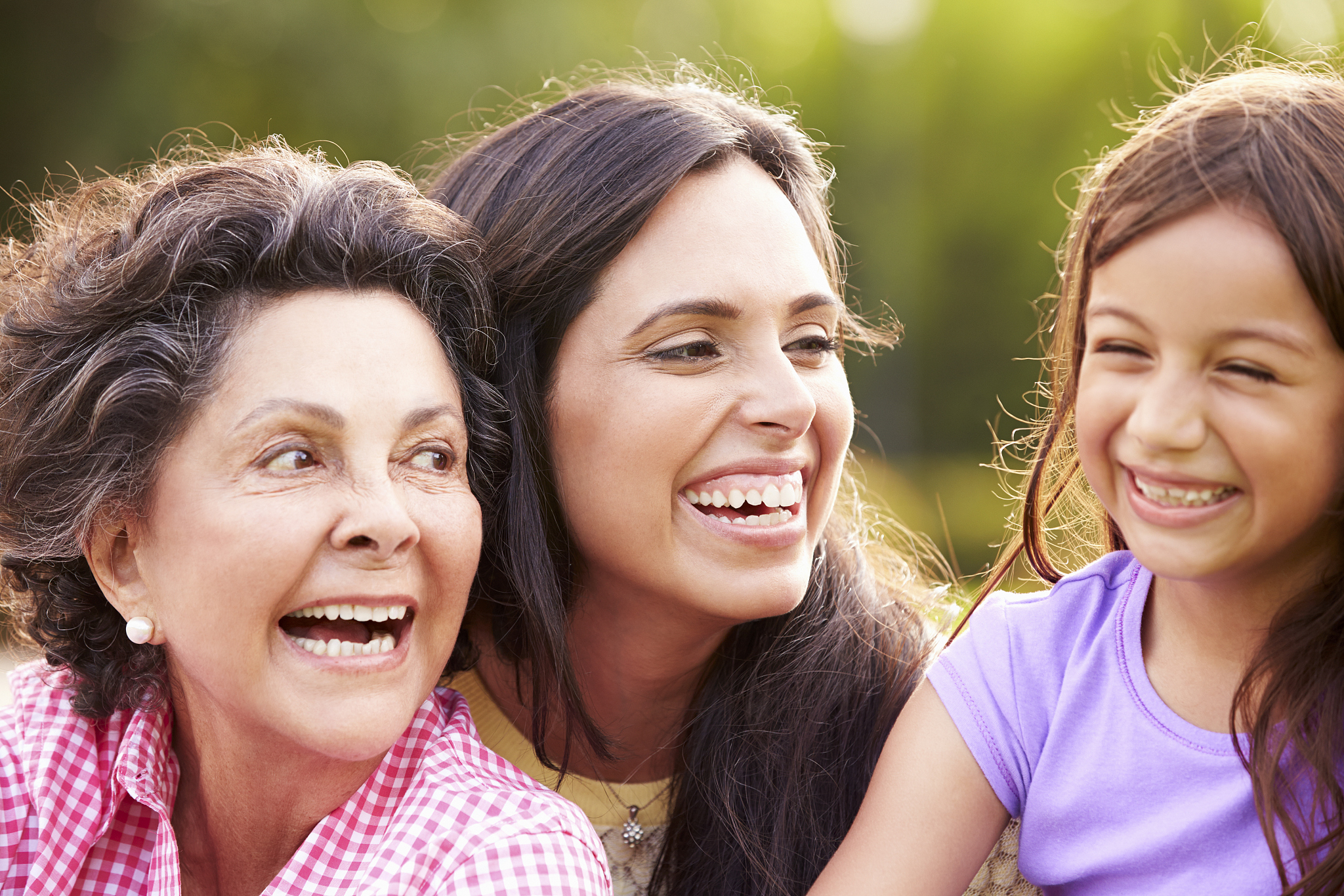 grandmother with granddaughter and mother in park