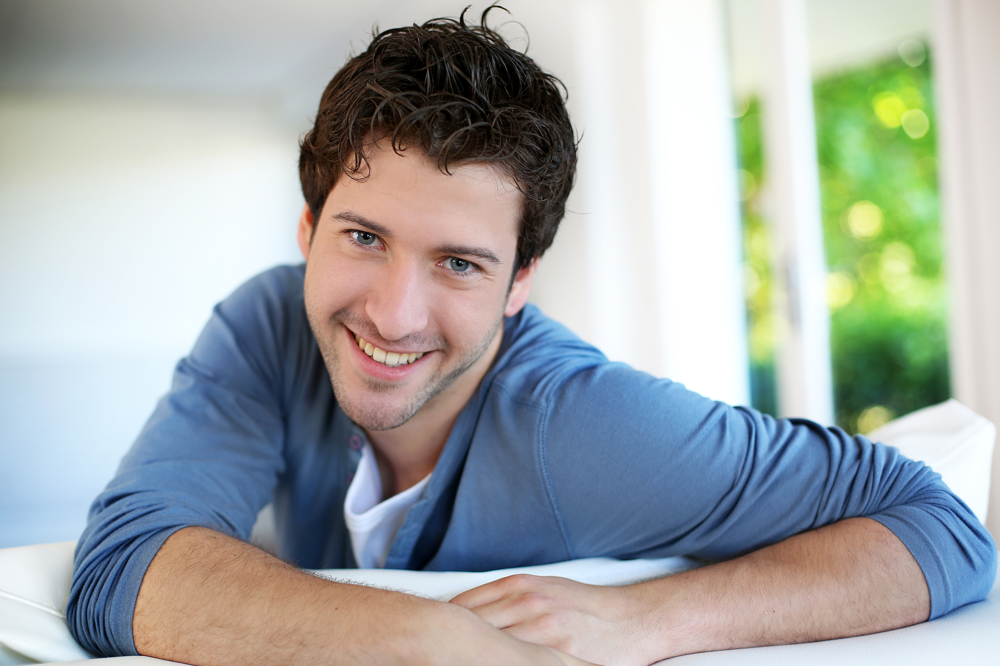 beautiful young man relaxing on sofa