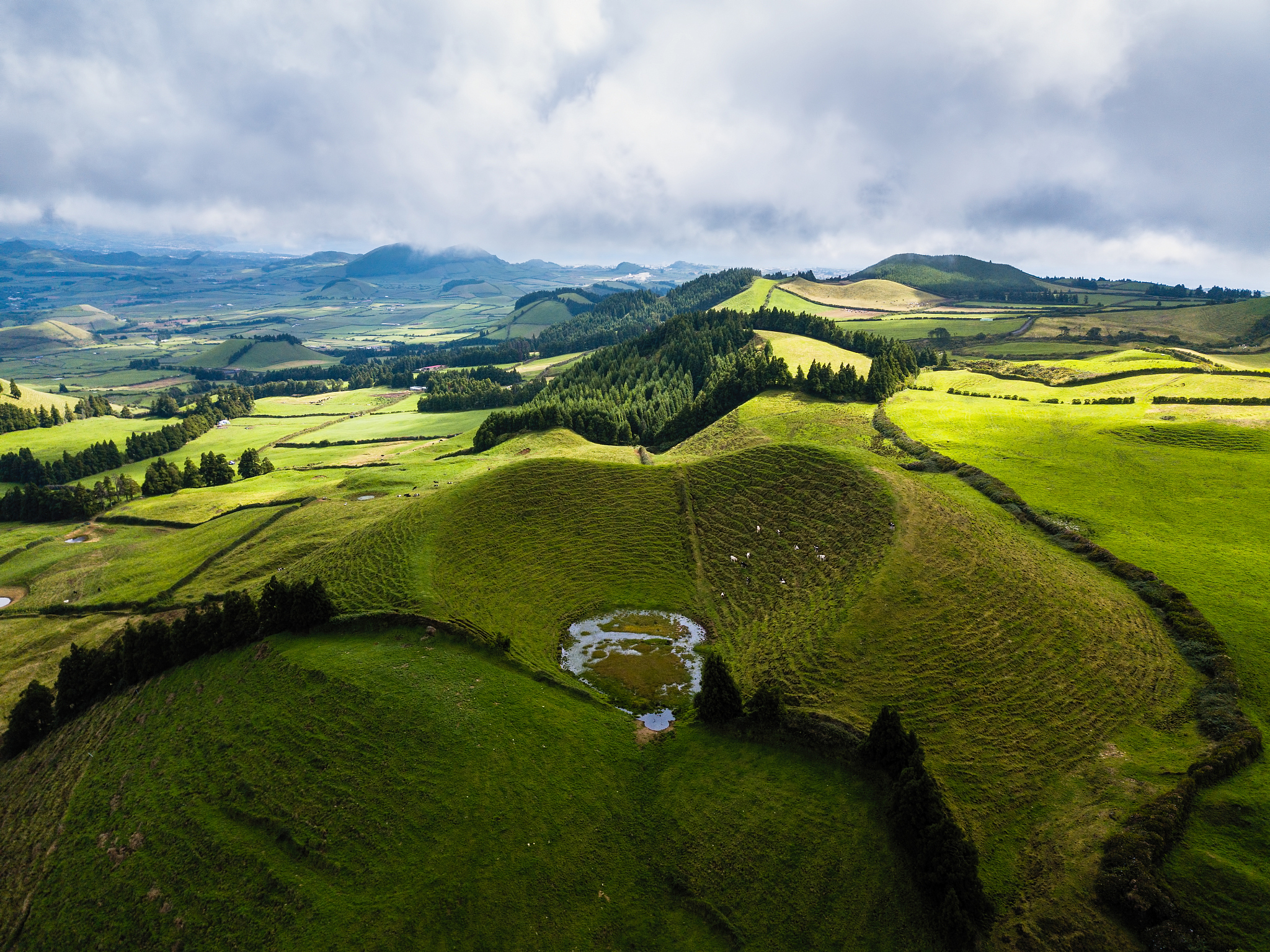 flying over green fields of san miguel island, azores, portugal.