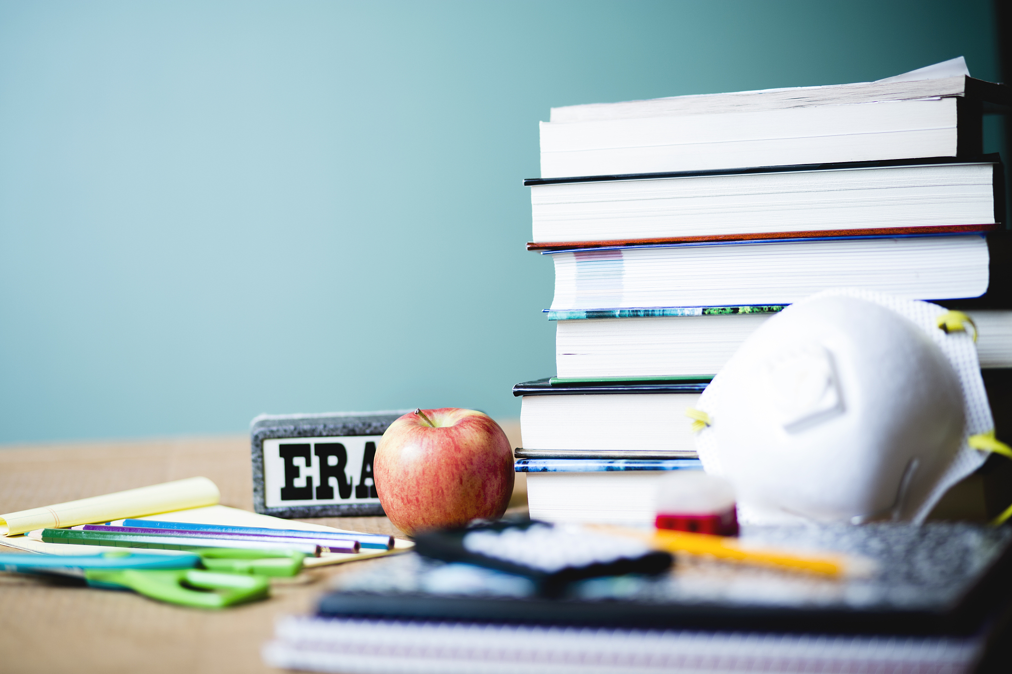 school books and supplies.  chalkboard background.