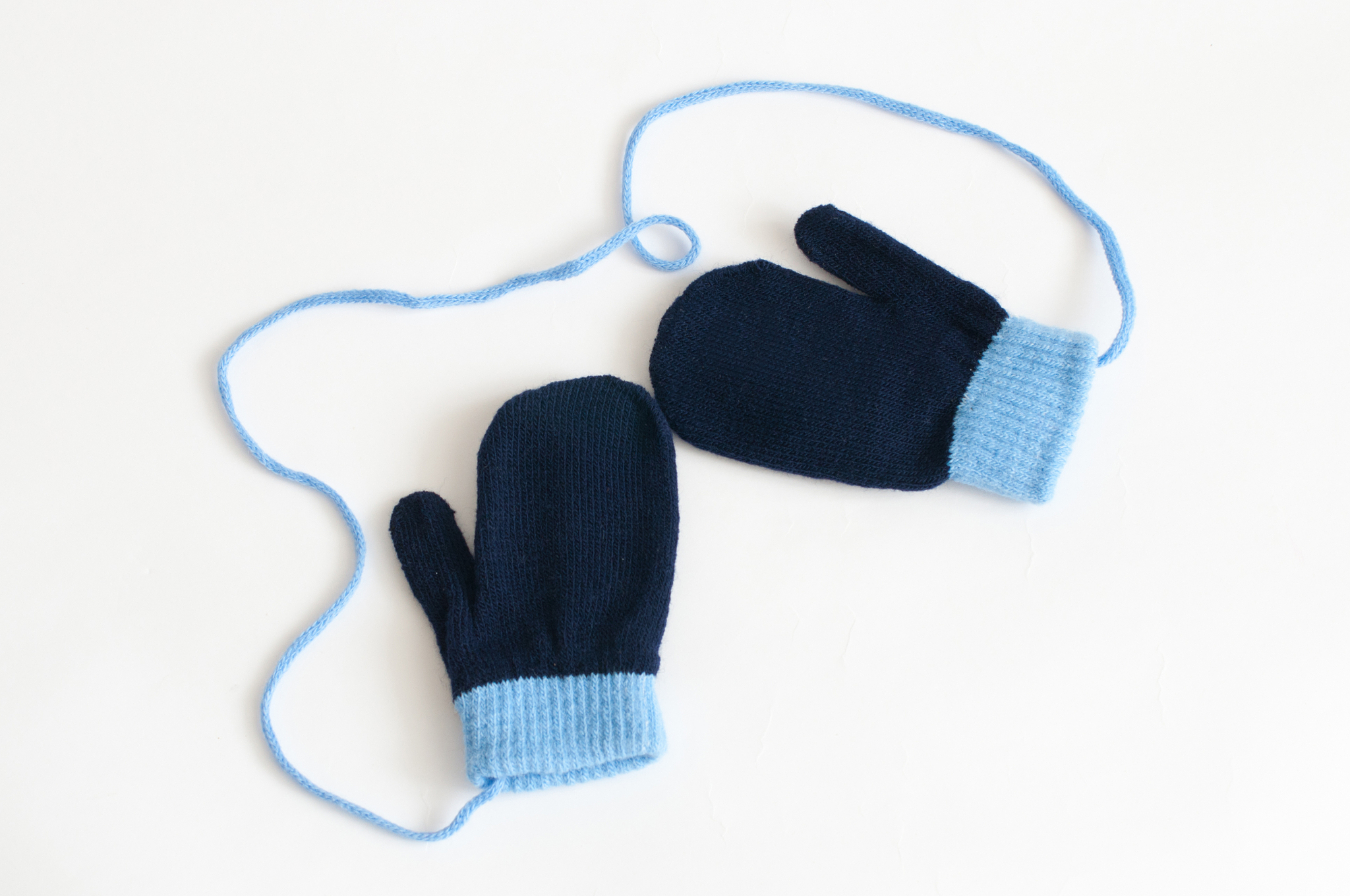 blue knitted mittens on a white background