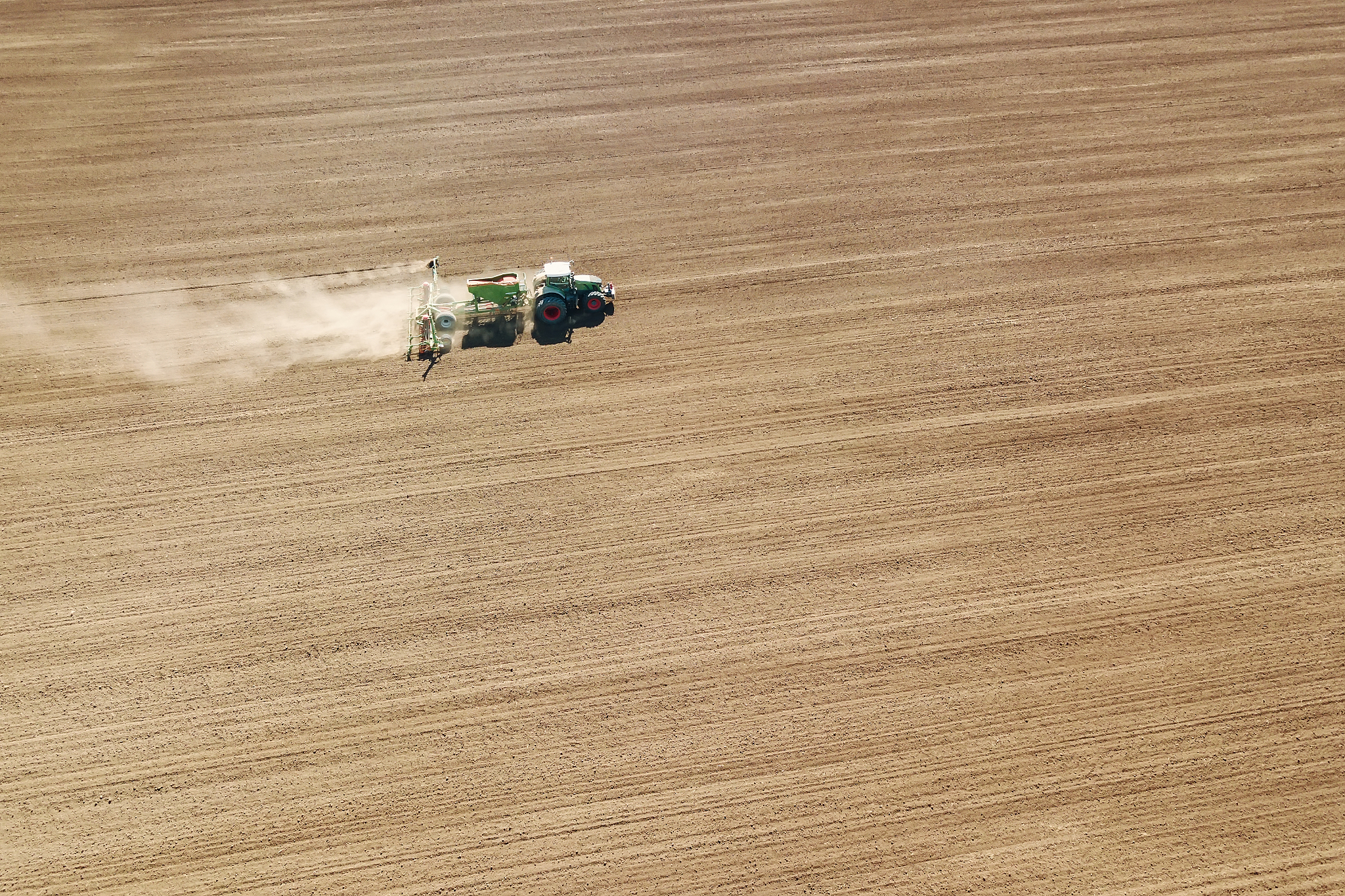 aerial tractor sowing crops at field