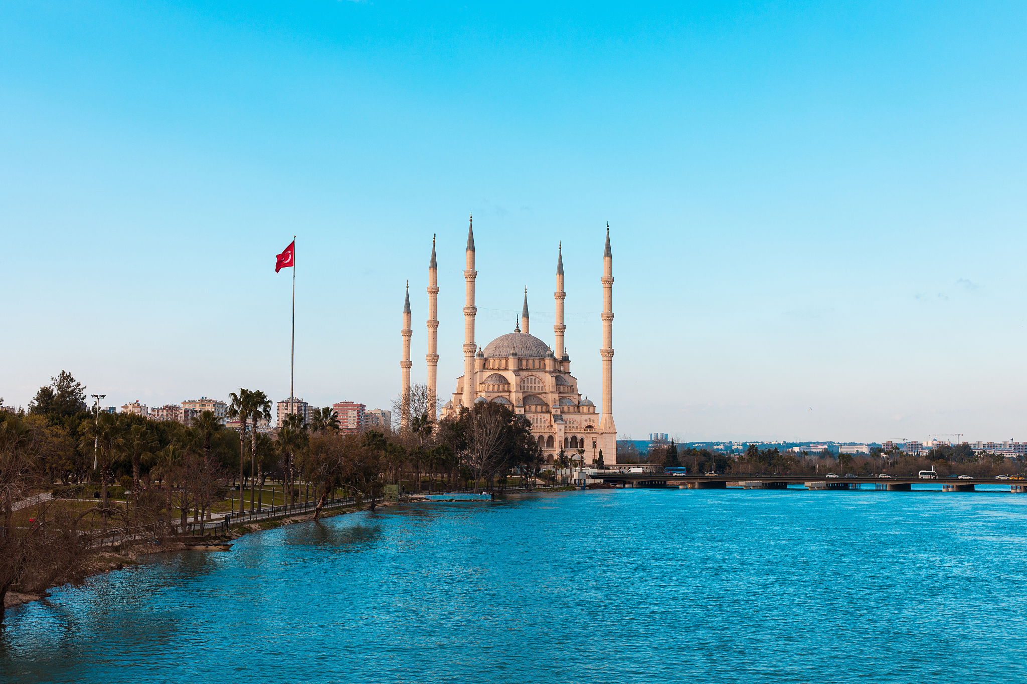 sabanci central mosque, old clock tower and stone bridge in adan