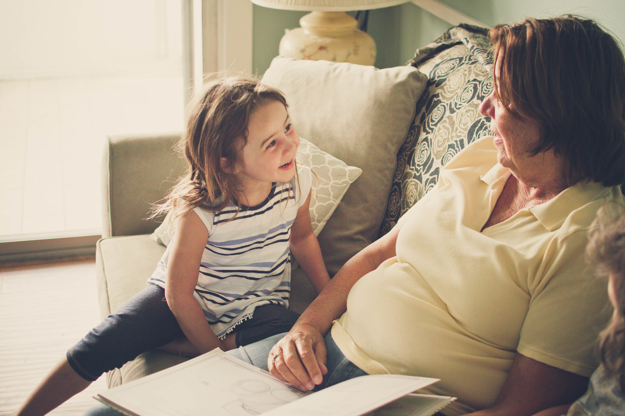 grandmother reading to her grandchildren.
