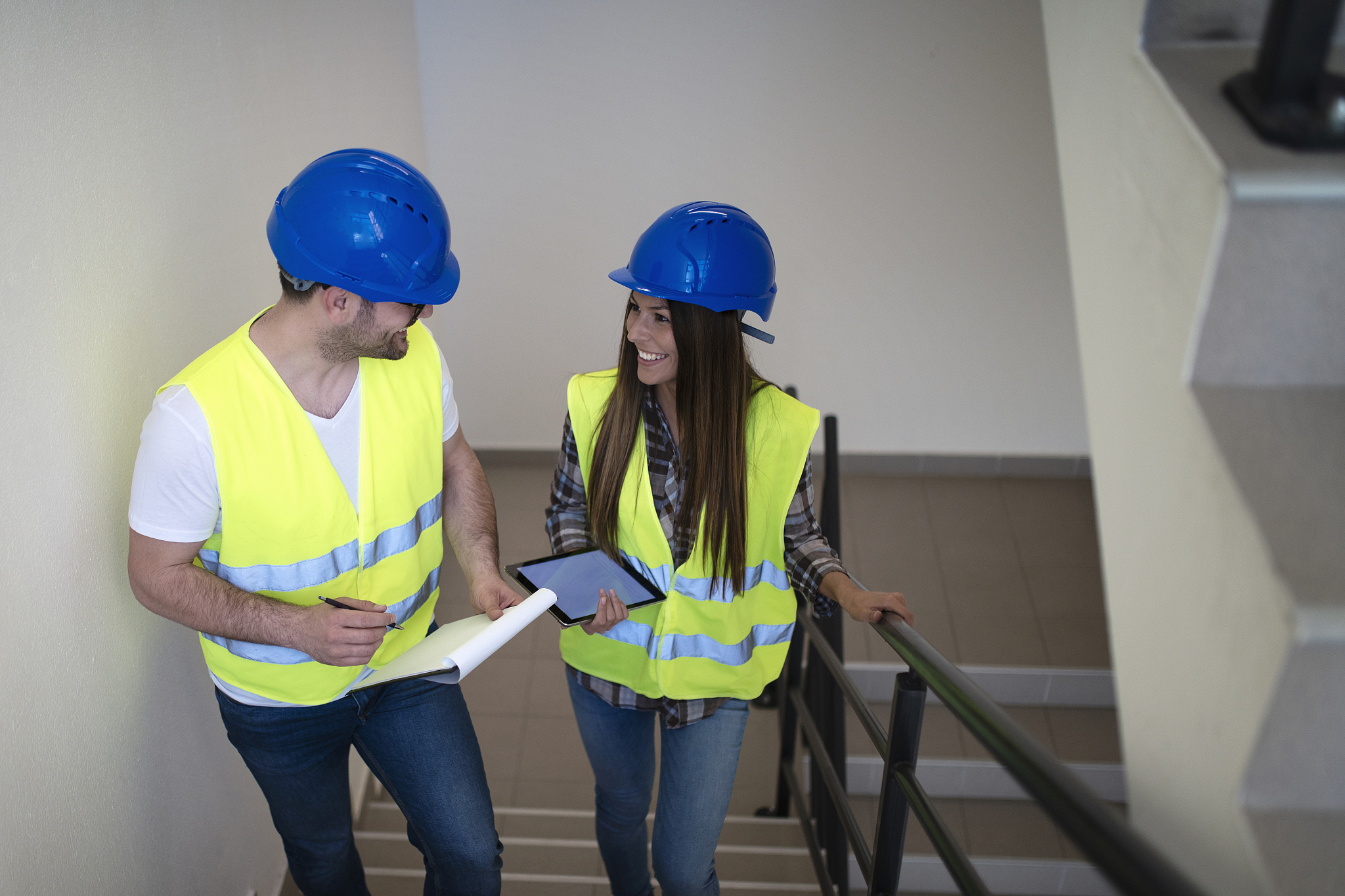 industrial workers with hardhat and reflective jacket walking th