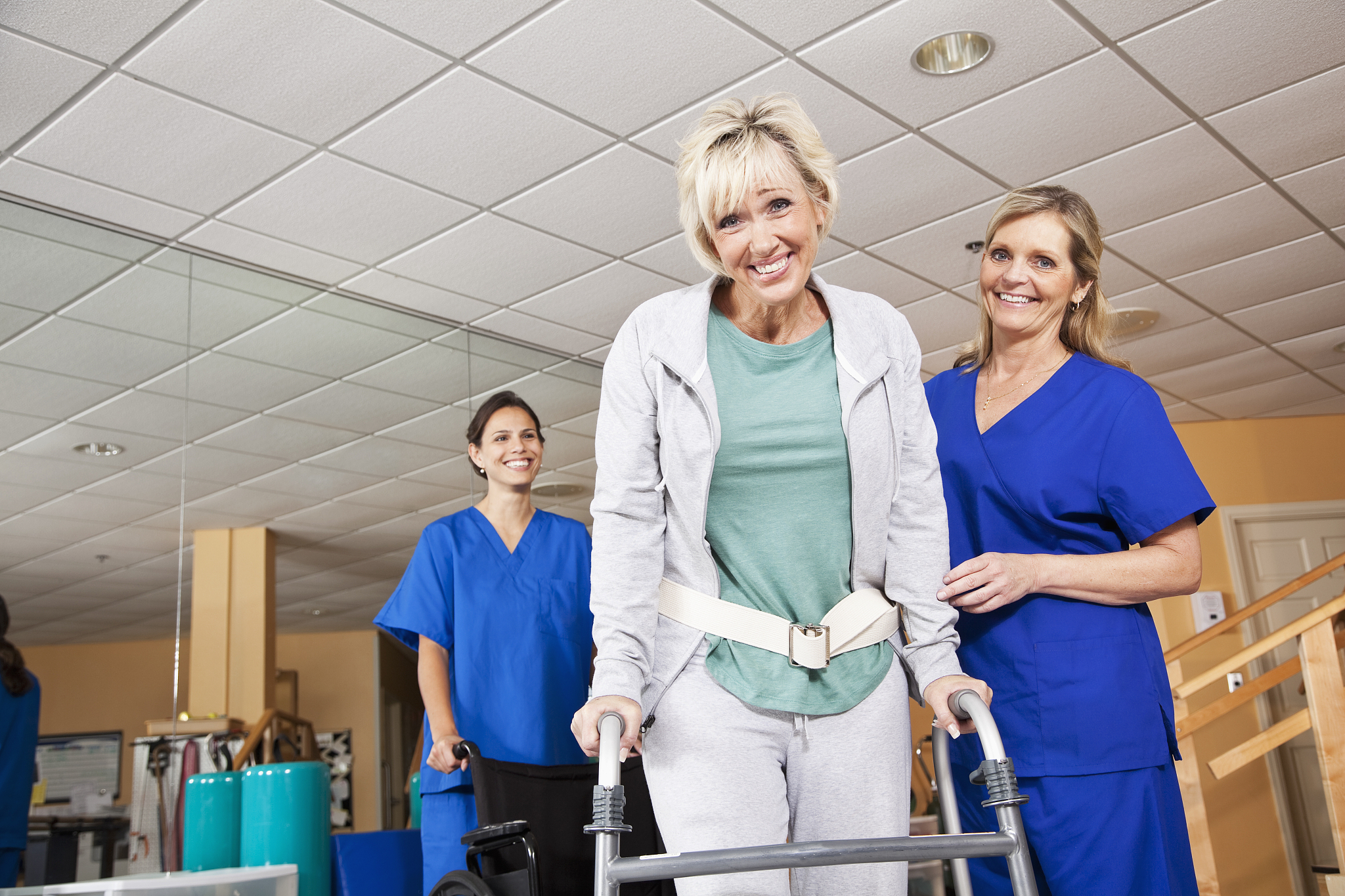 mature woman with physical therapists