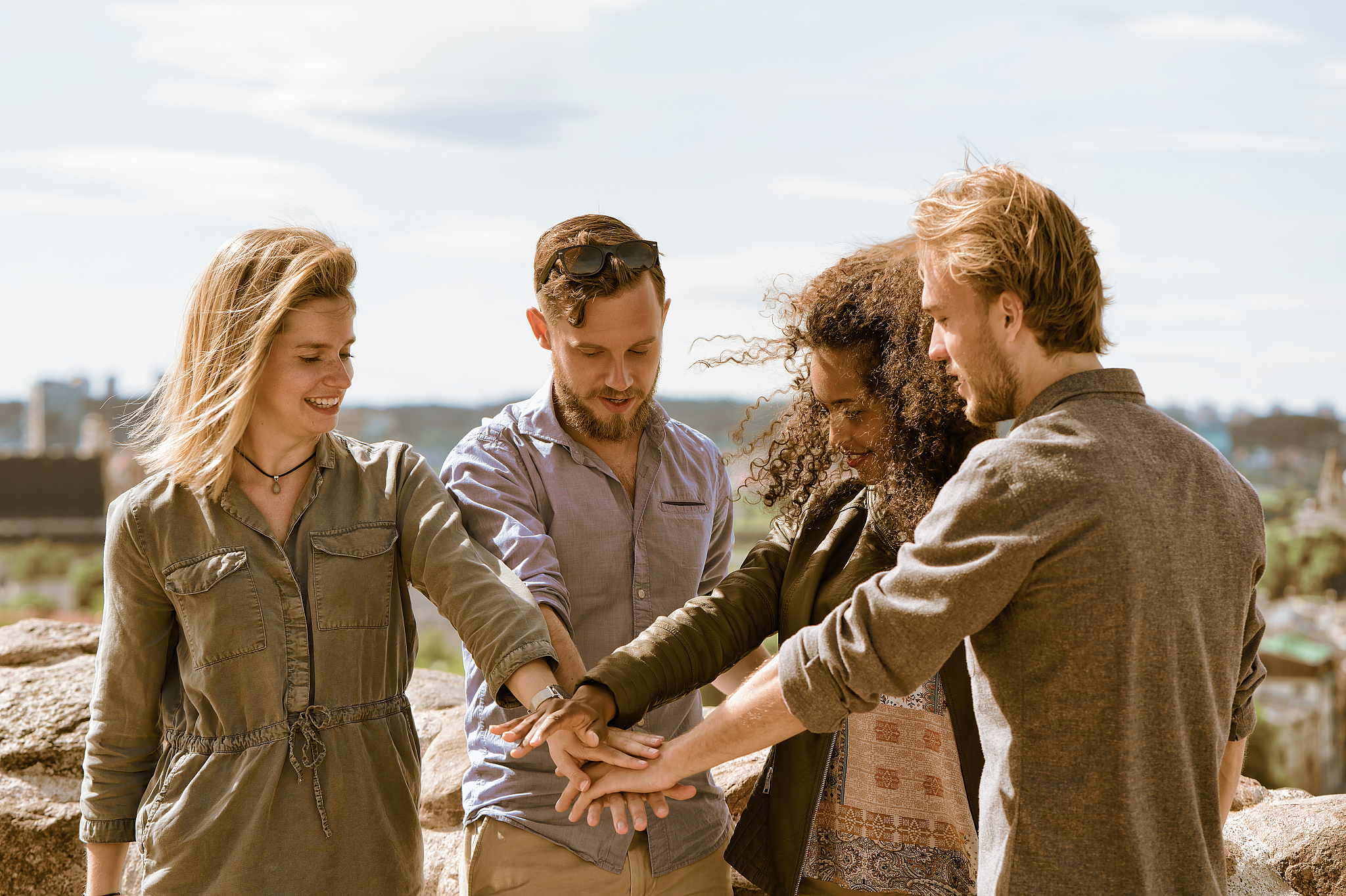 group of cheerful young multiracial friends holding hands unity 