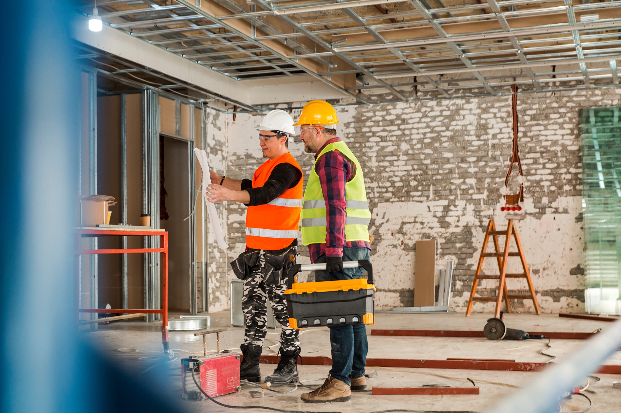 construction workers looking at blueprint on construction site