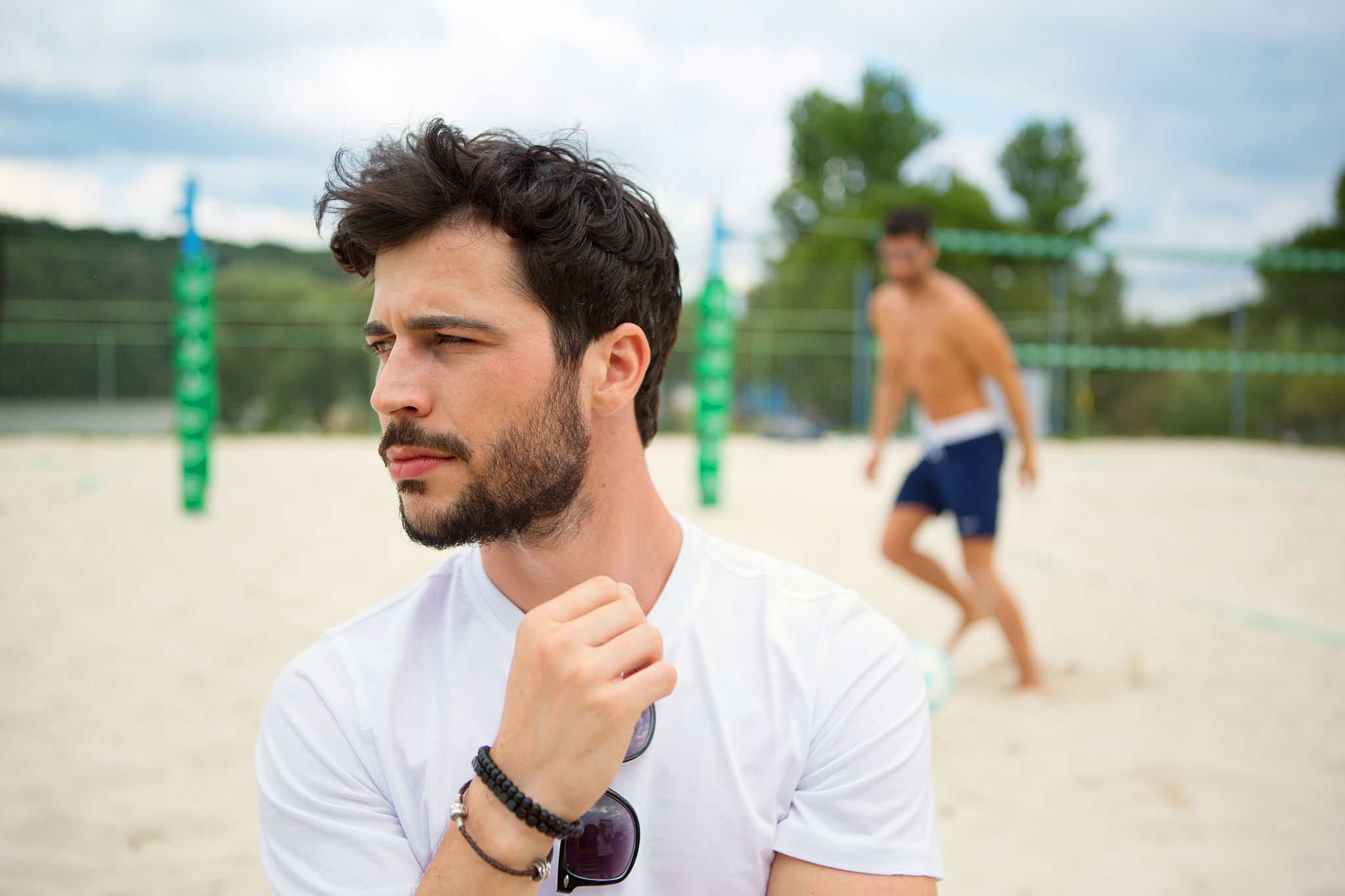 young man on beach volleyball field