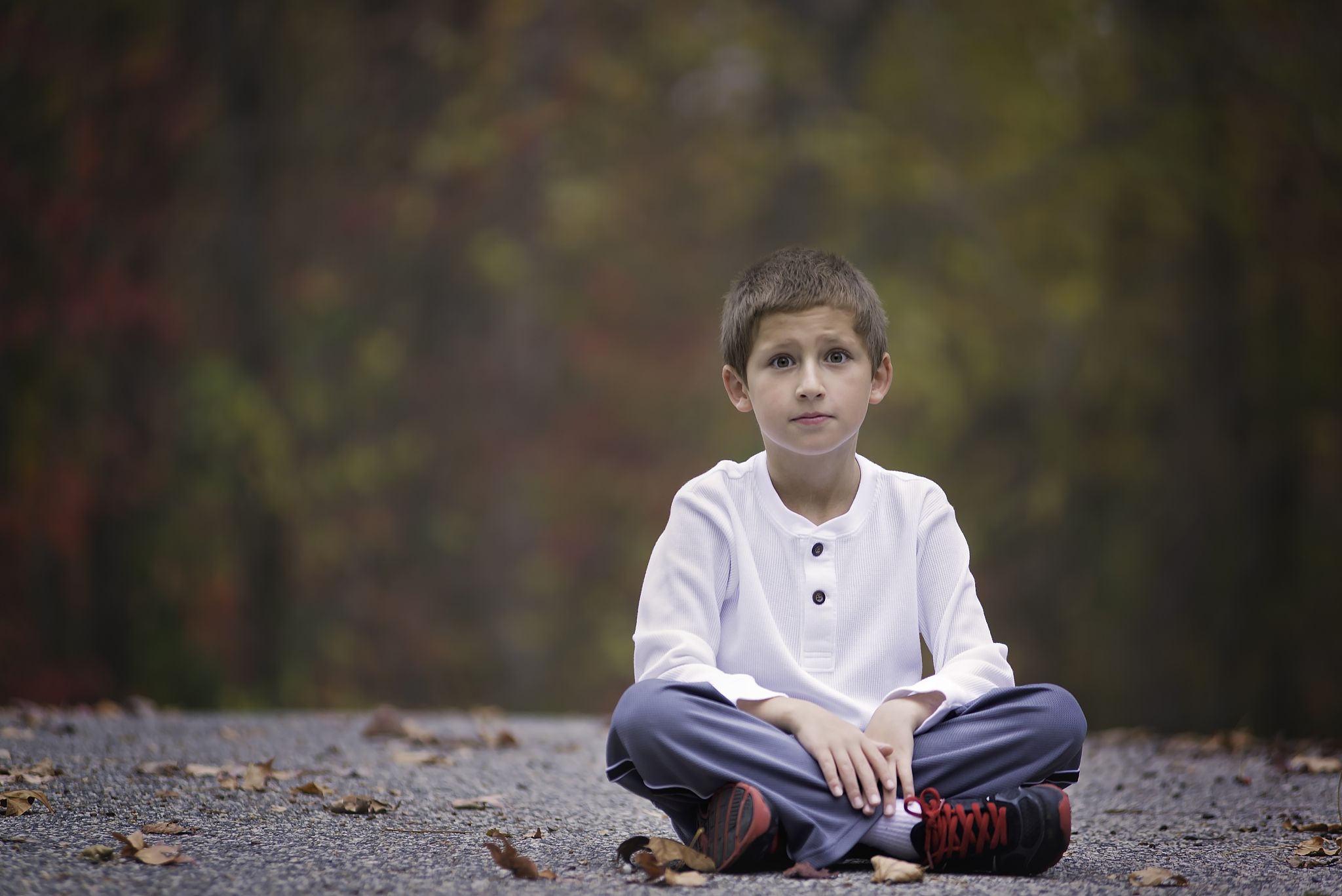 young boy playing outdoors in the fall