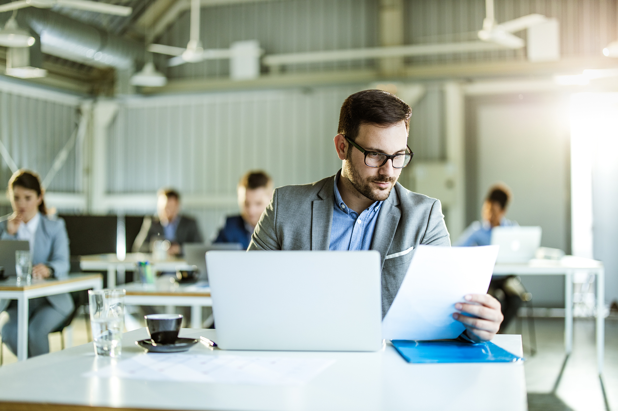 young businessman working on laptop and paperwork in the office.
