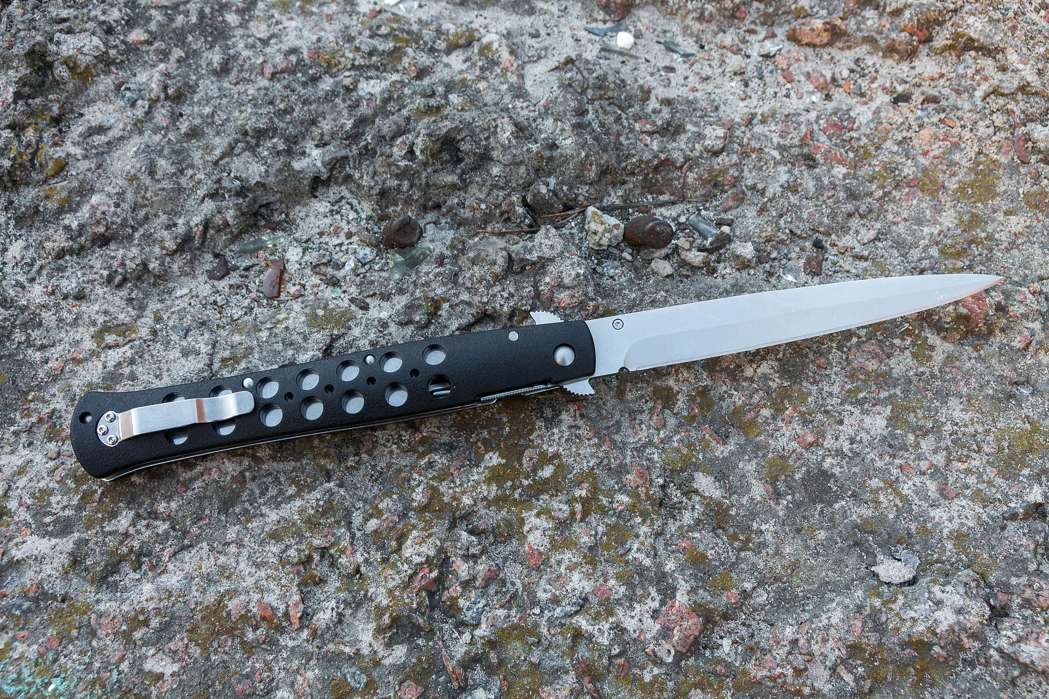 large knife on stone background. the handle of the knife on the 