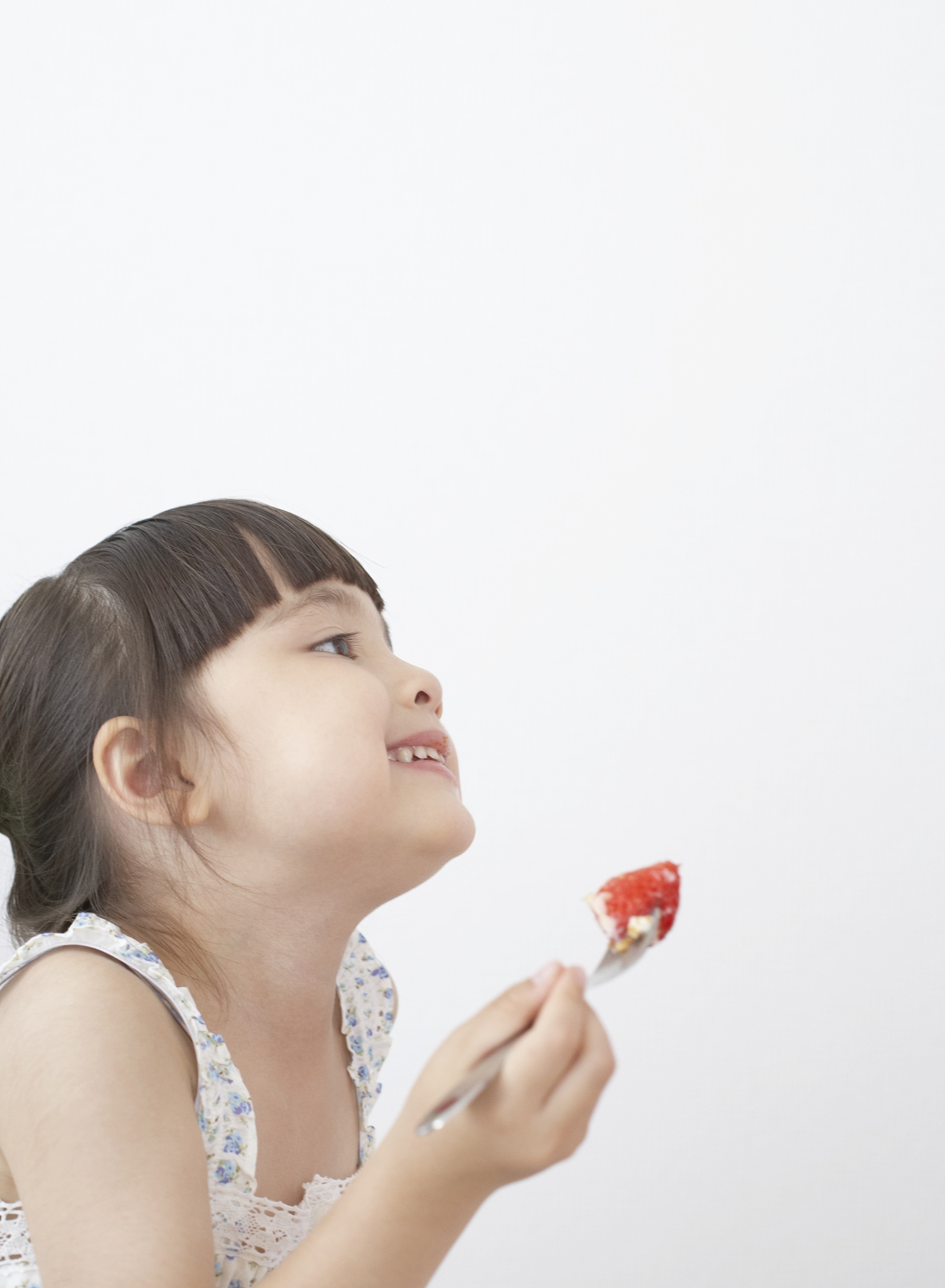 french girl eating strawberry with smiling