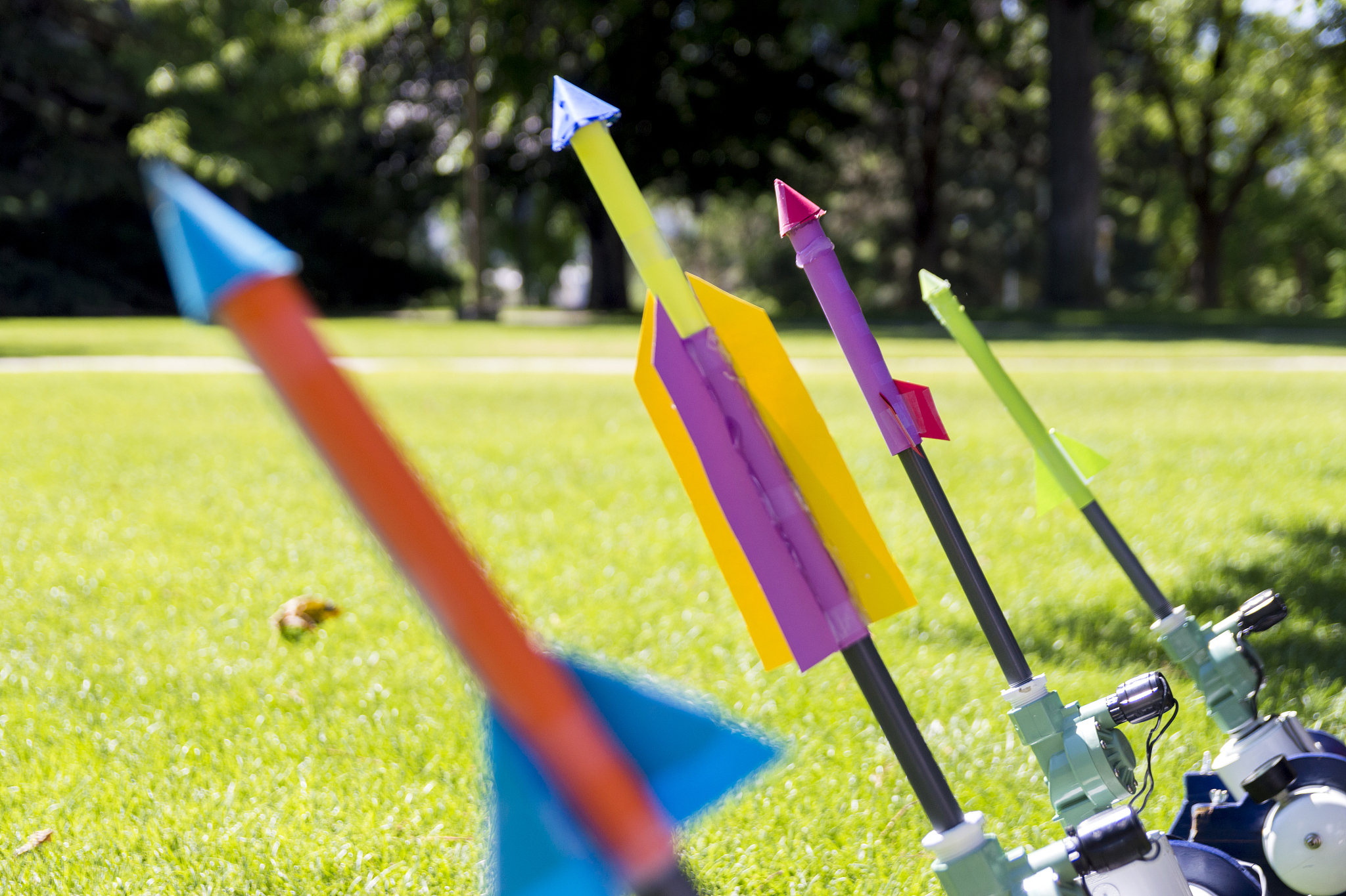 colorful paper rockets posed on a compressed air launcher