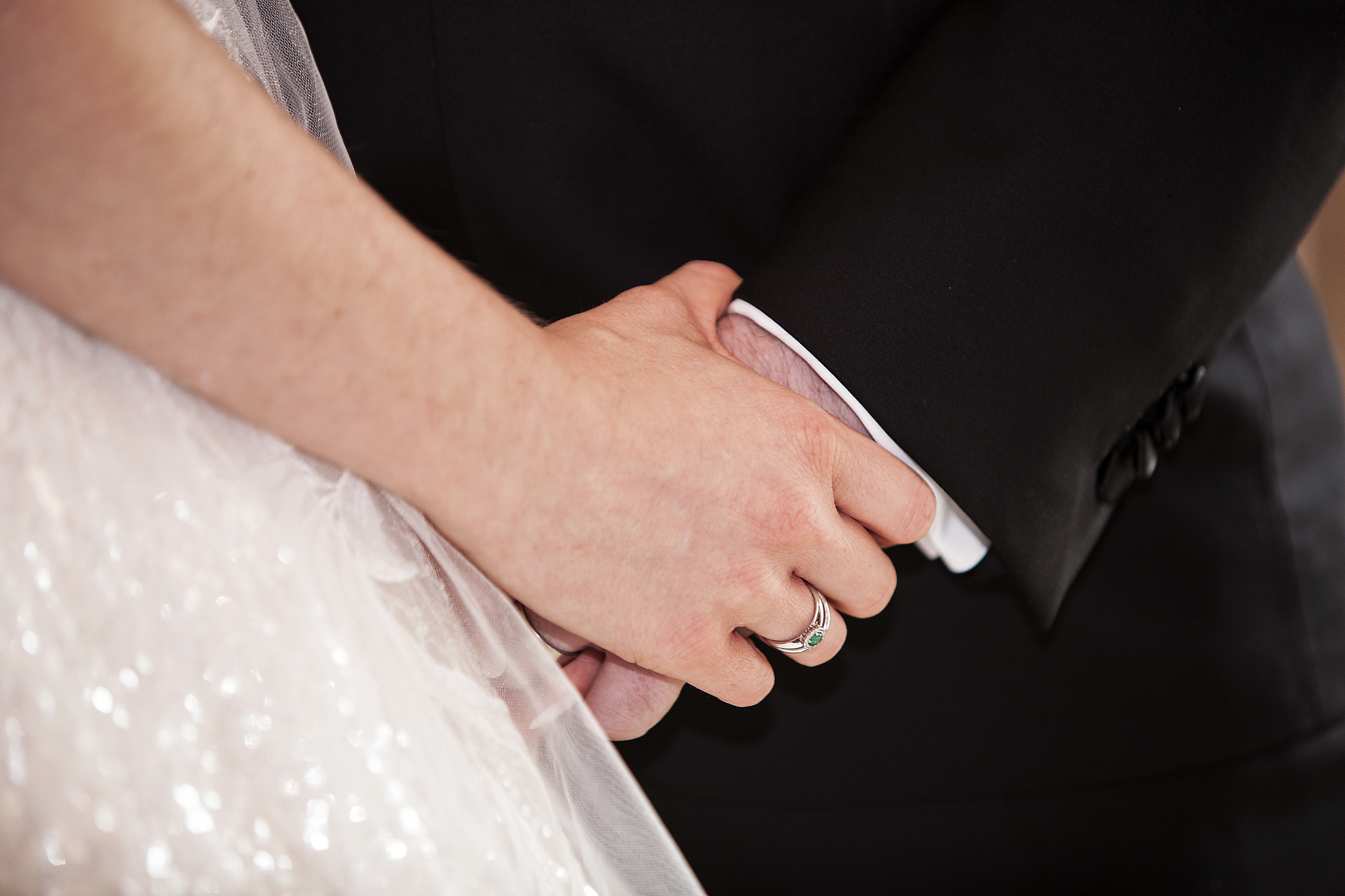 bride and groom at marriage hold each other, closeup of hands