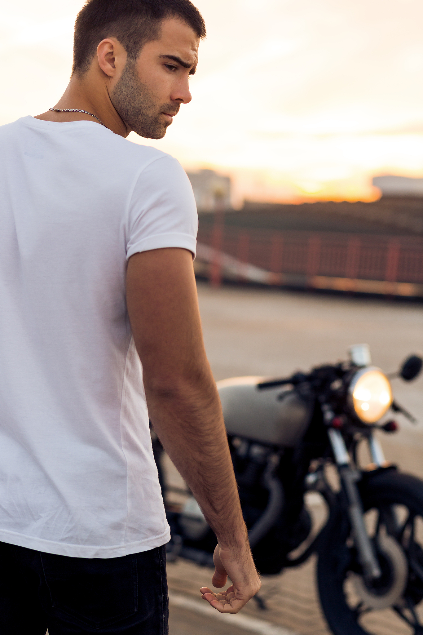 brutal man near his cafe racer custom motorbike.