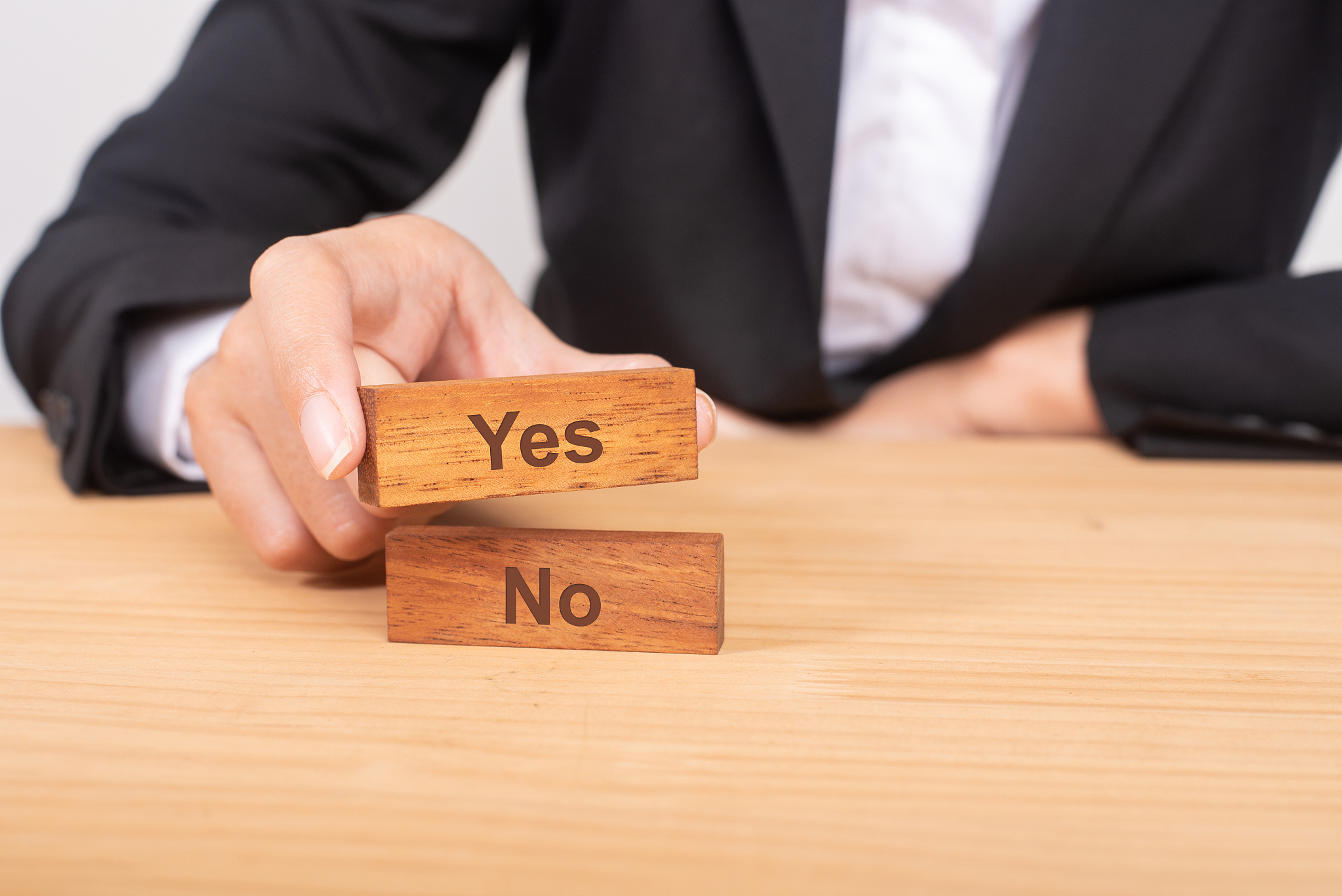 hand of businesswoman choosing wood blog with icon and word yes 