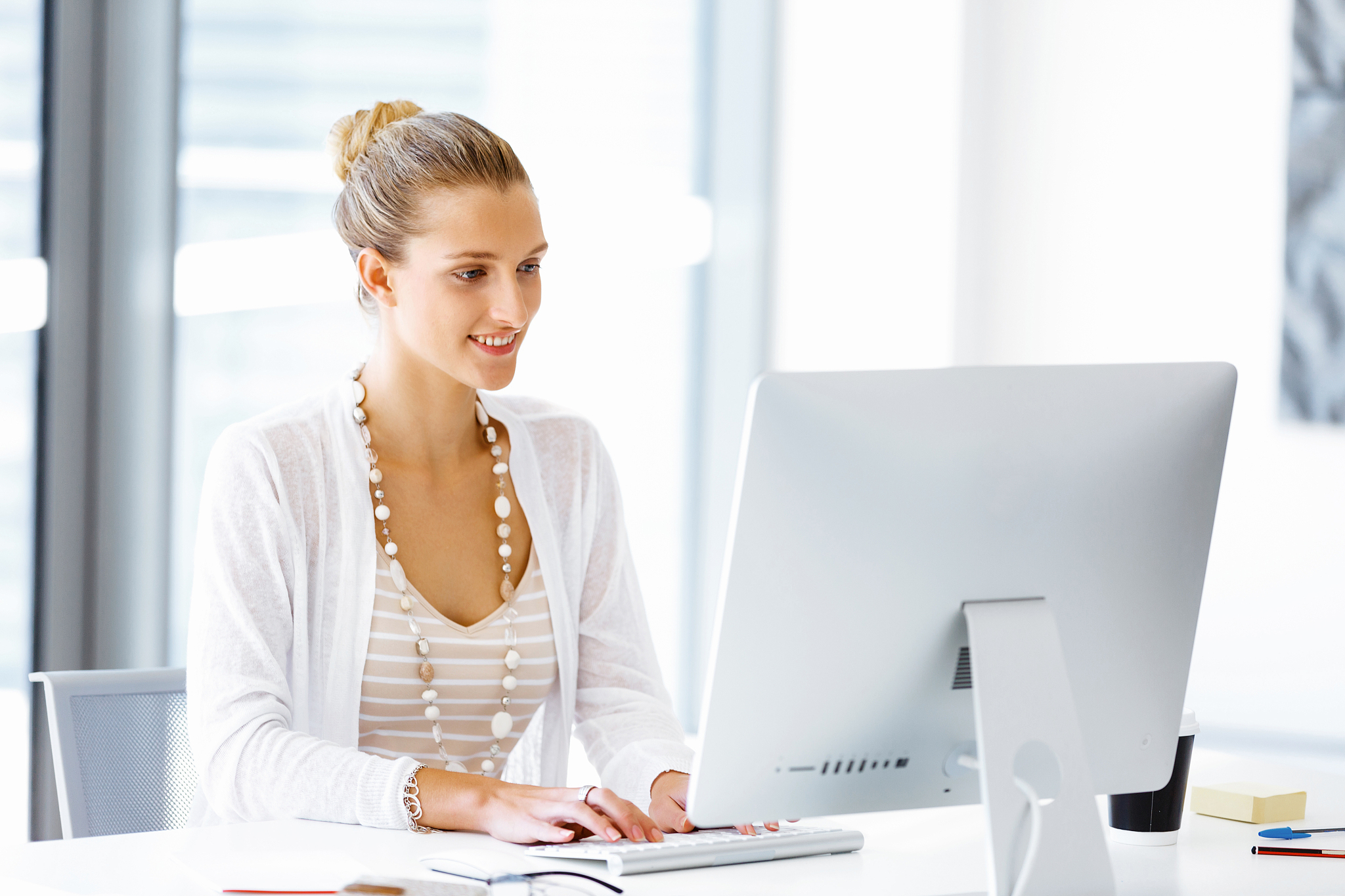 attractive office worker sitting at desk. attractive woman sitti