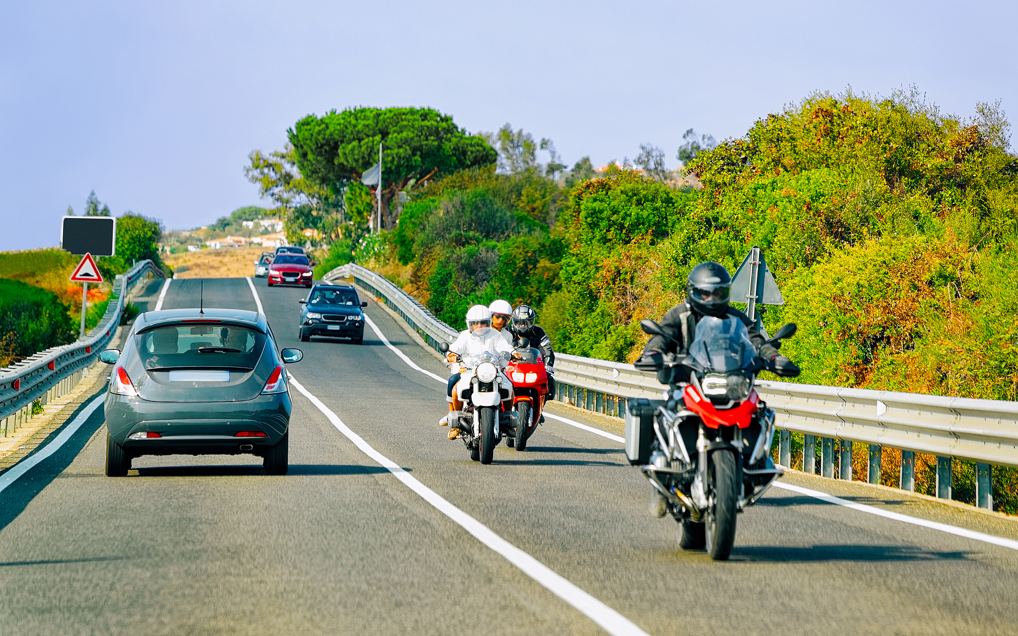 motorcycles and cars in road in costa smeralda reflex