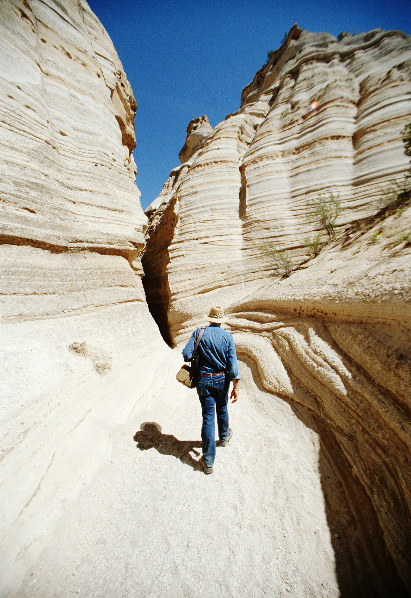 man hiking on rocks, rear view