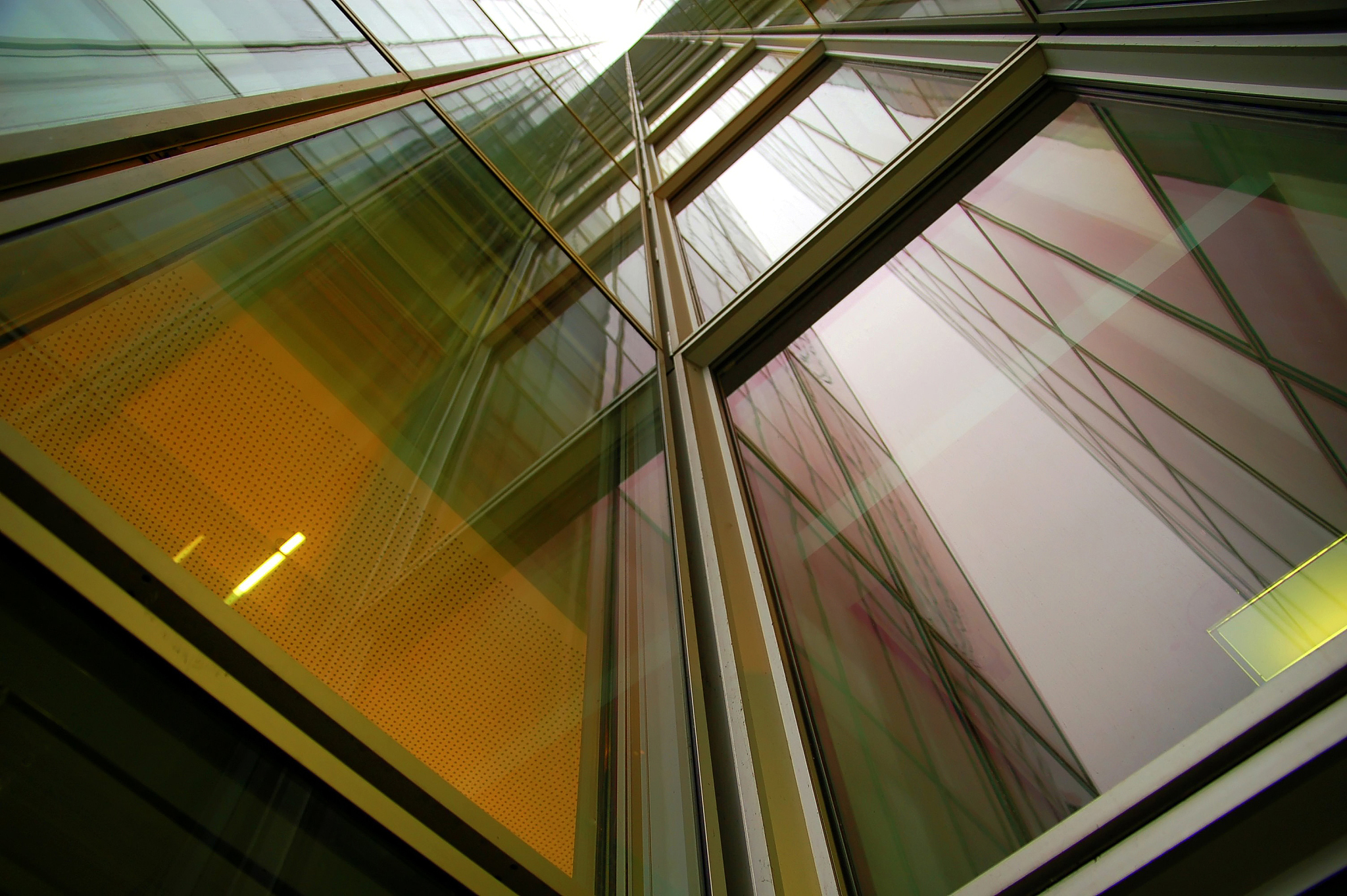 looking up a glass and steel office building