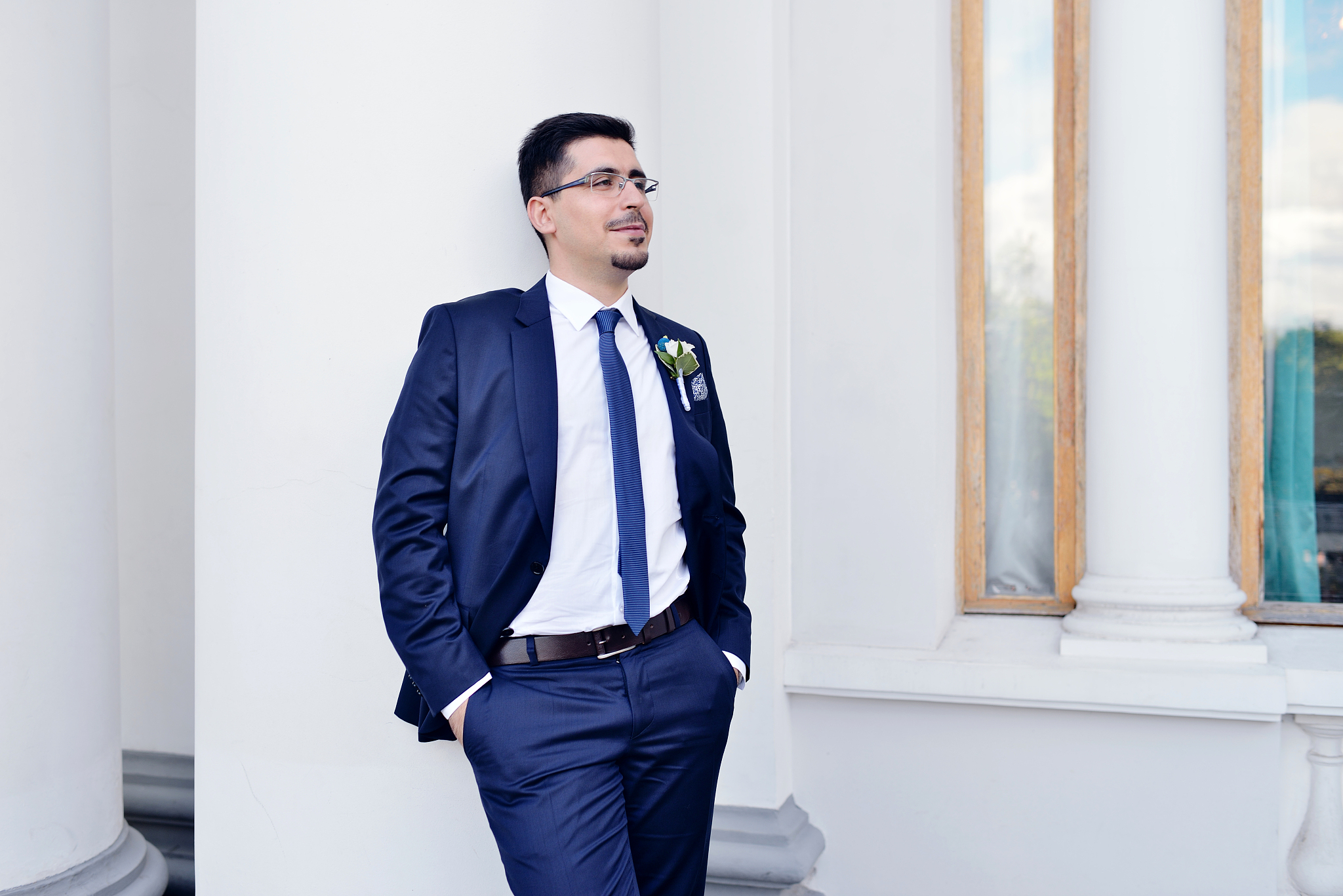 handsome groom in suit in the nature