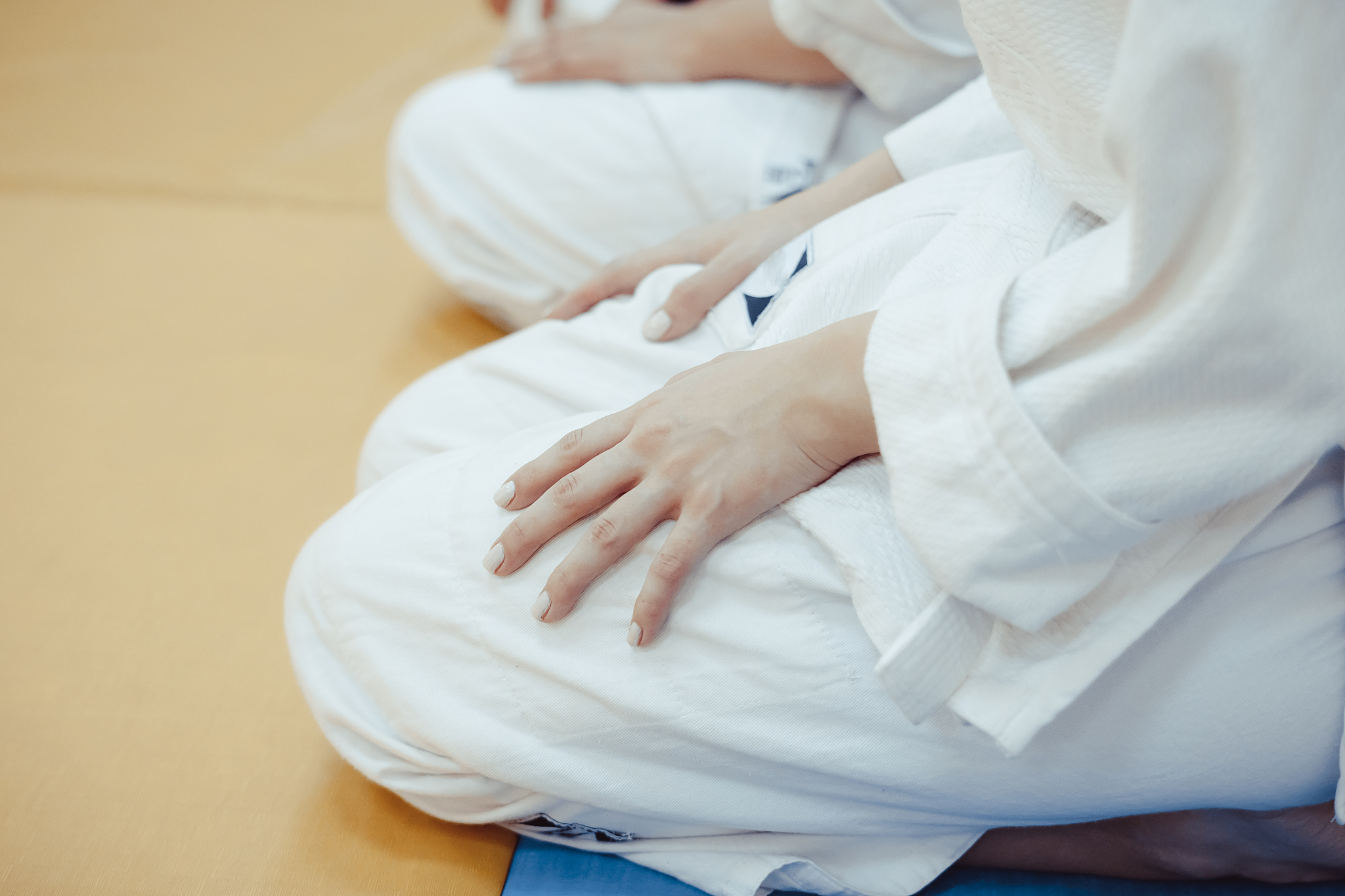 students sitting in a kimono in the gym