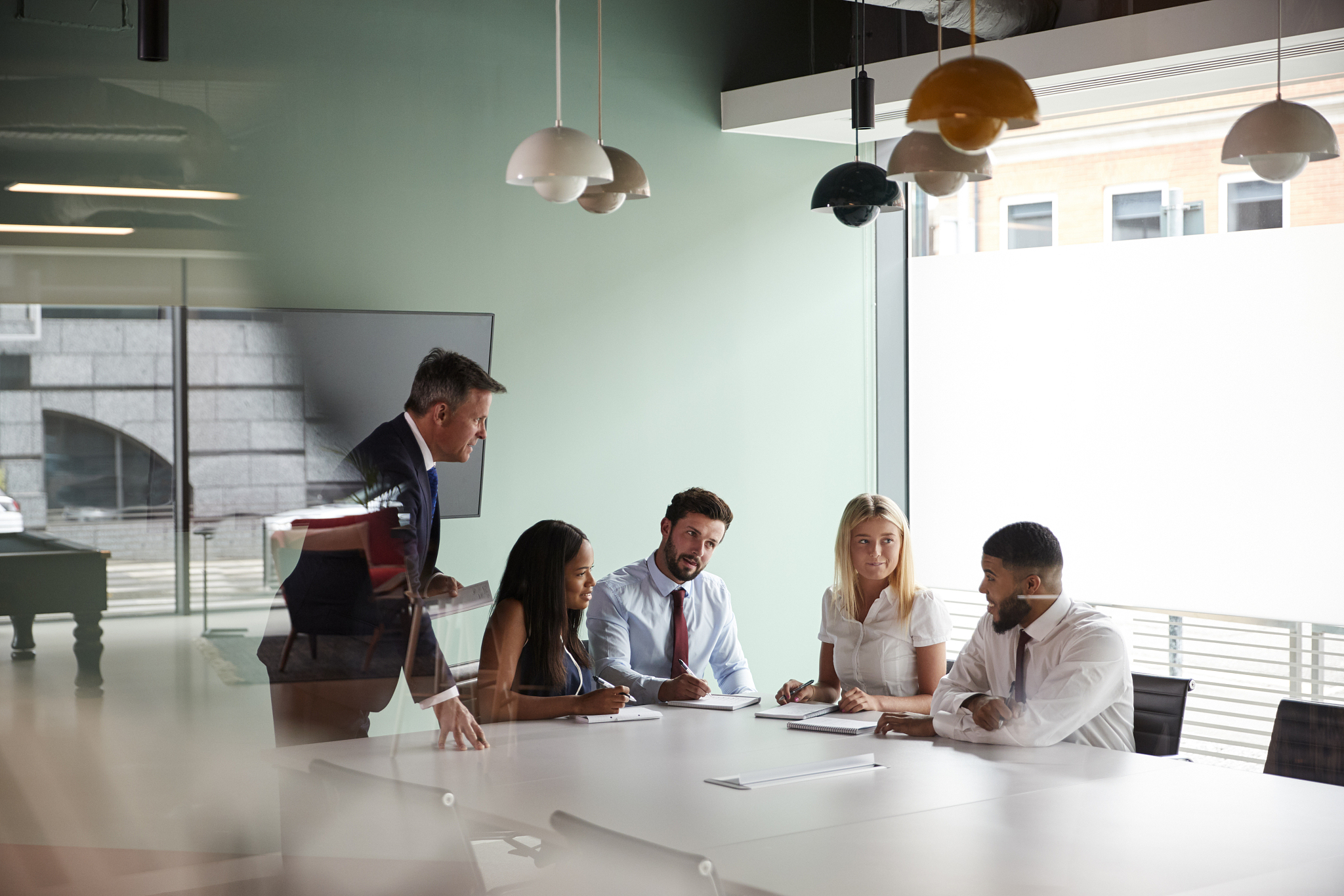 group meeting around table at graduate recruitment assessment da