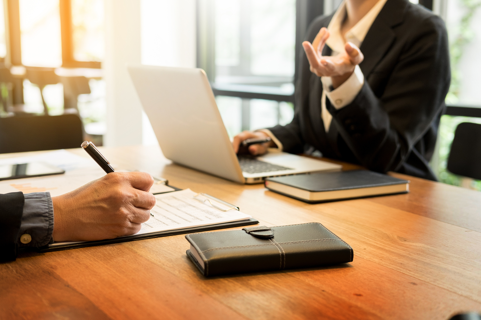 midsection of businesspeople working at table in office