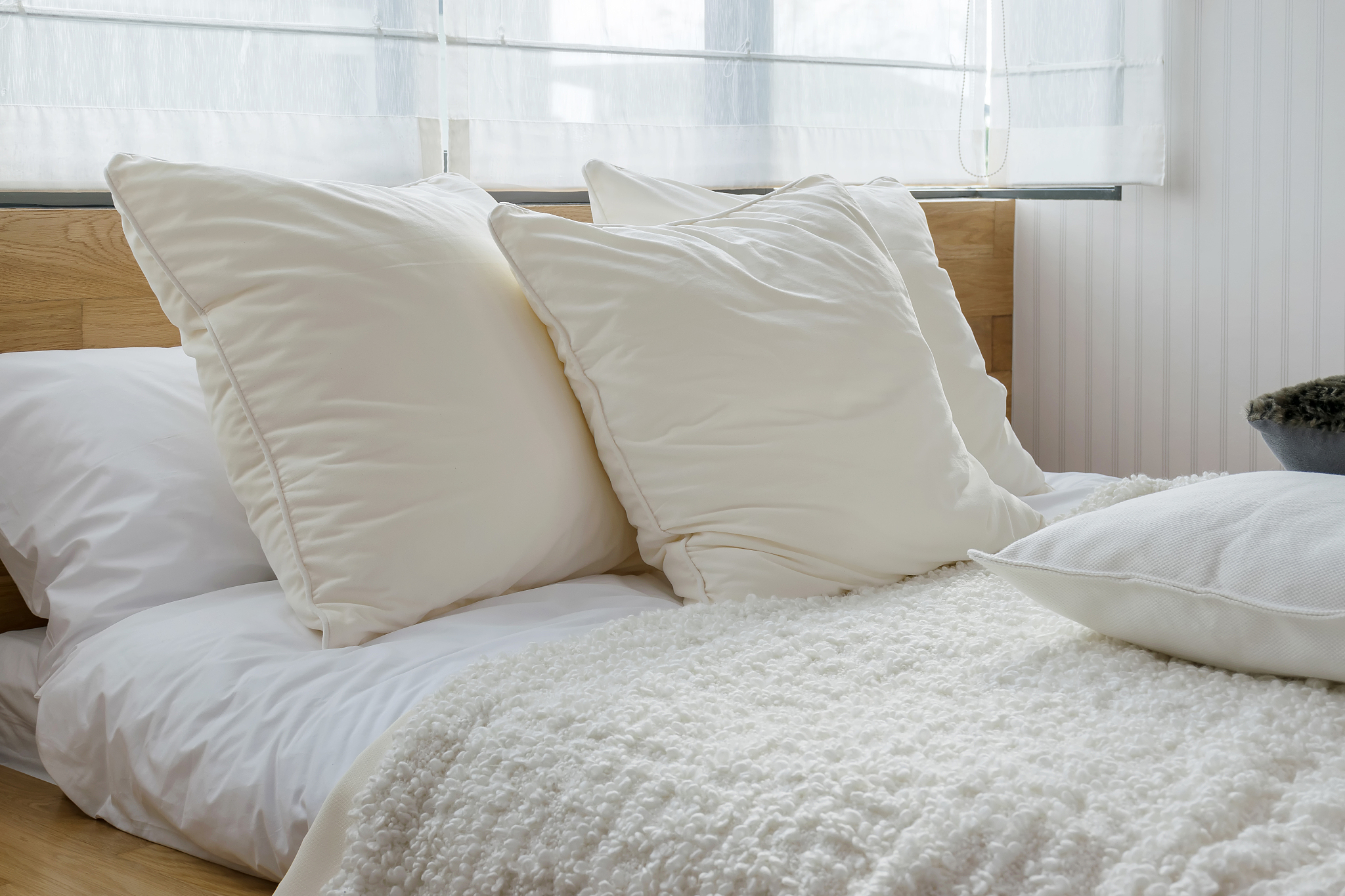 white pillows on bed at home