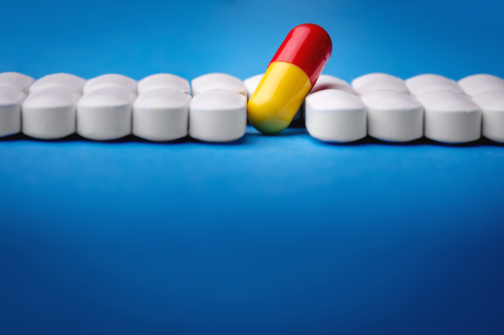 one red pill among white pills. concept of uniqueness