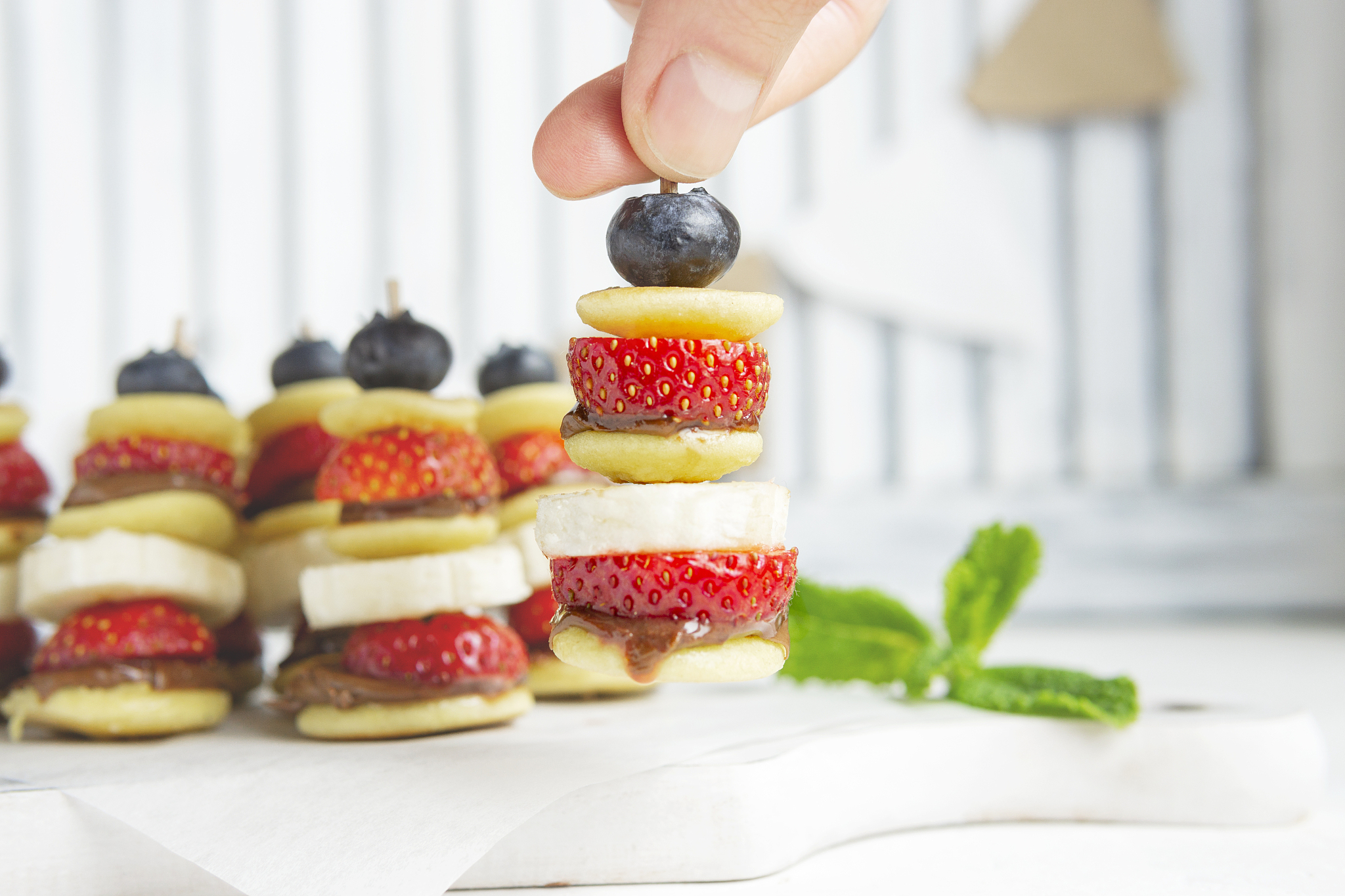 mini pancakes canape with berries, chocolate cream and banana, n