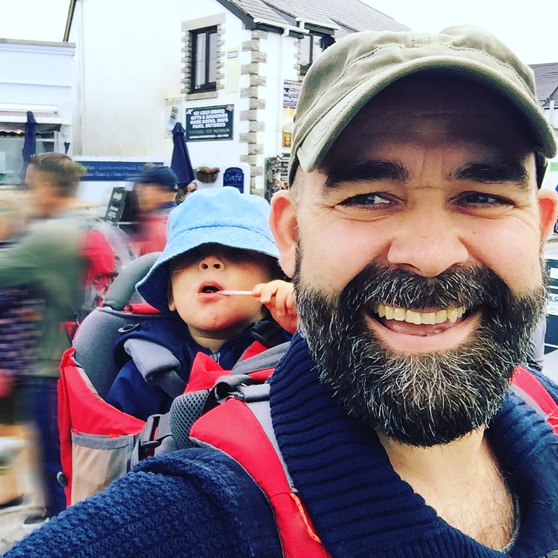 father walking with little boy on his back