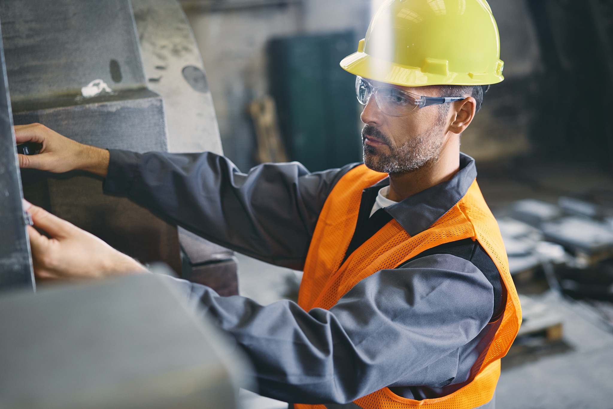 man wearing protective workwear working in factory