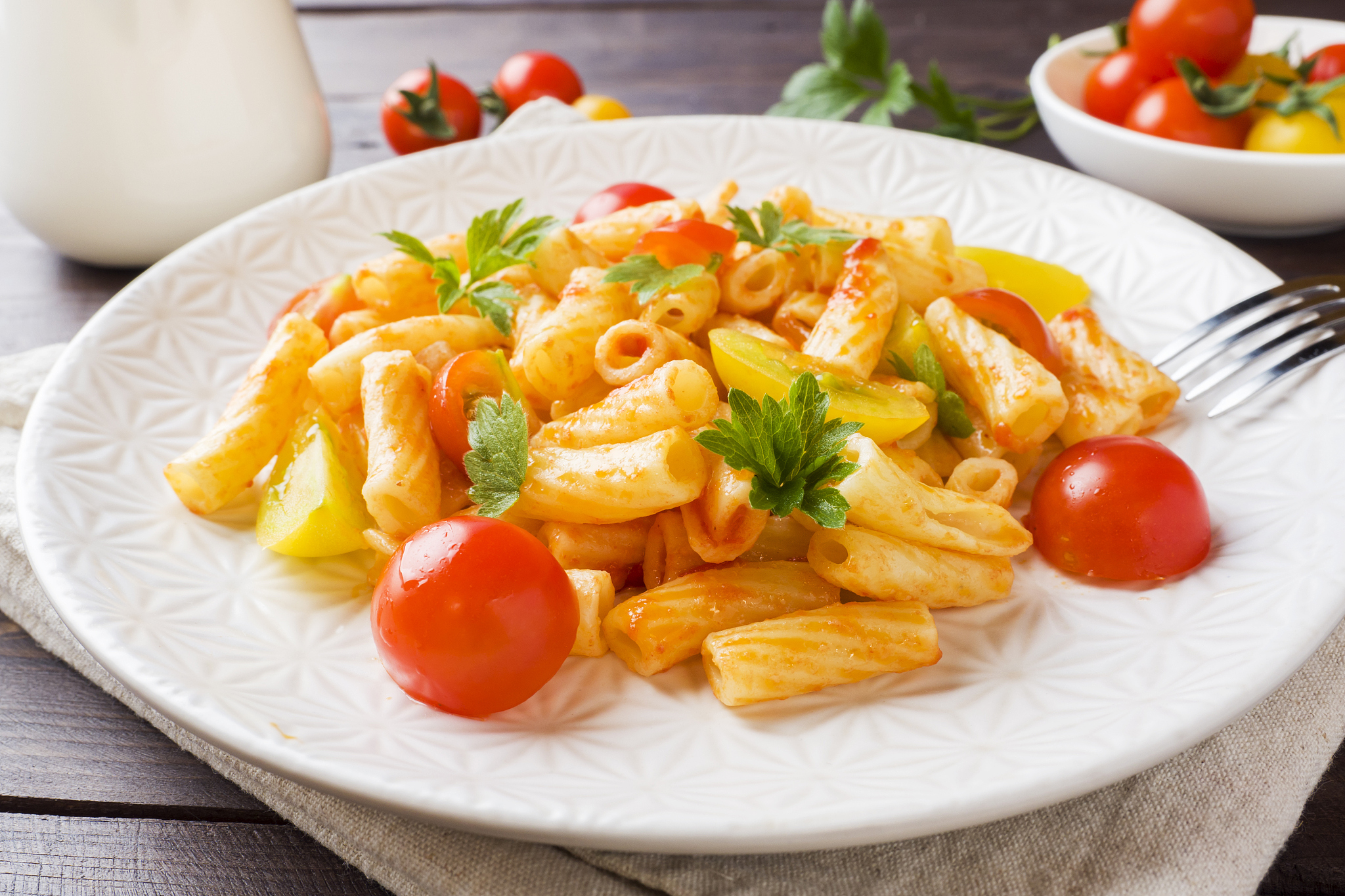macaroni, pasta in tomato sauce and cheese in a plate on a woode