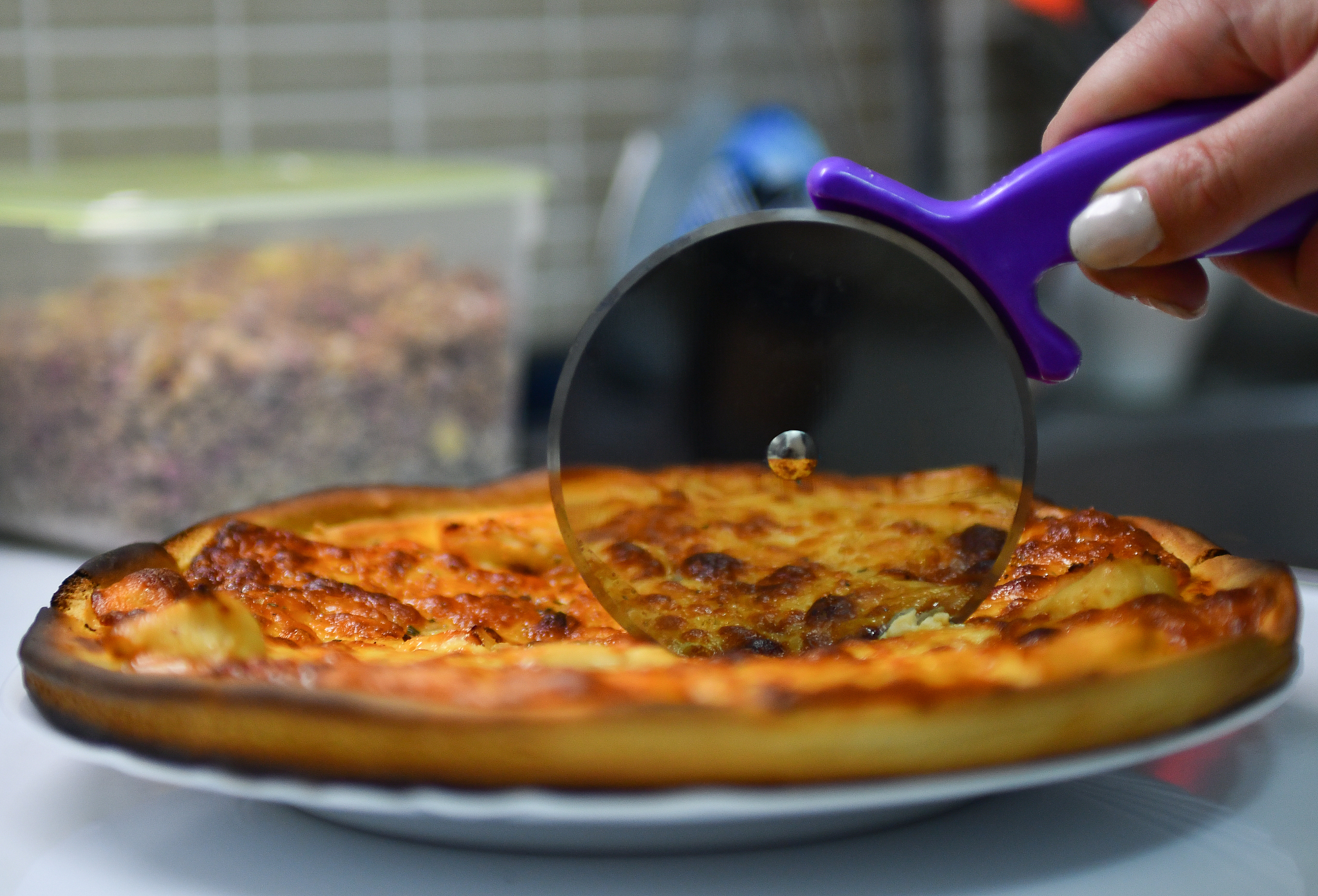 super sharp pizza cutter cutting through pizza margherita