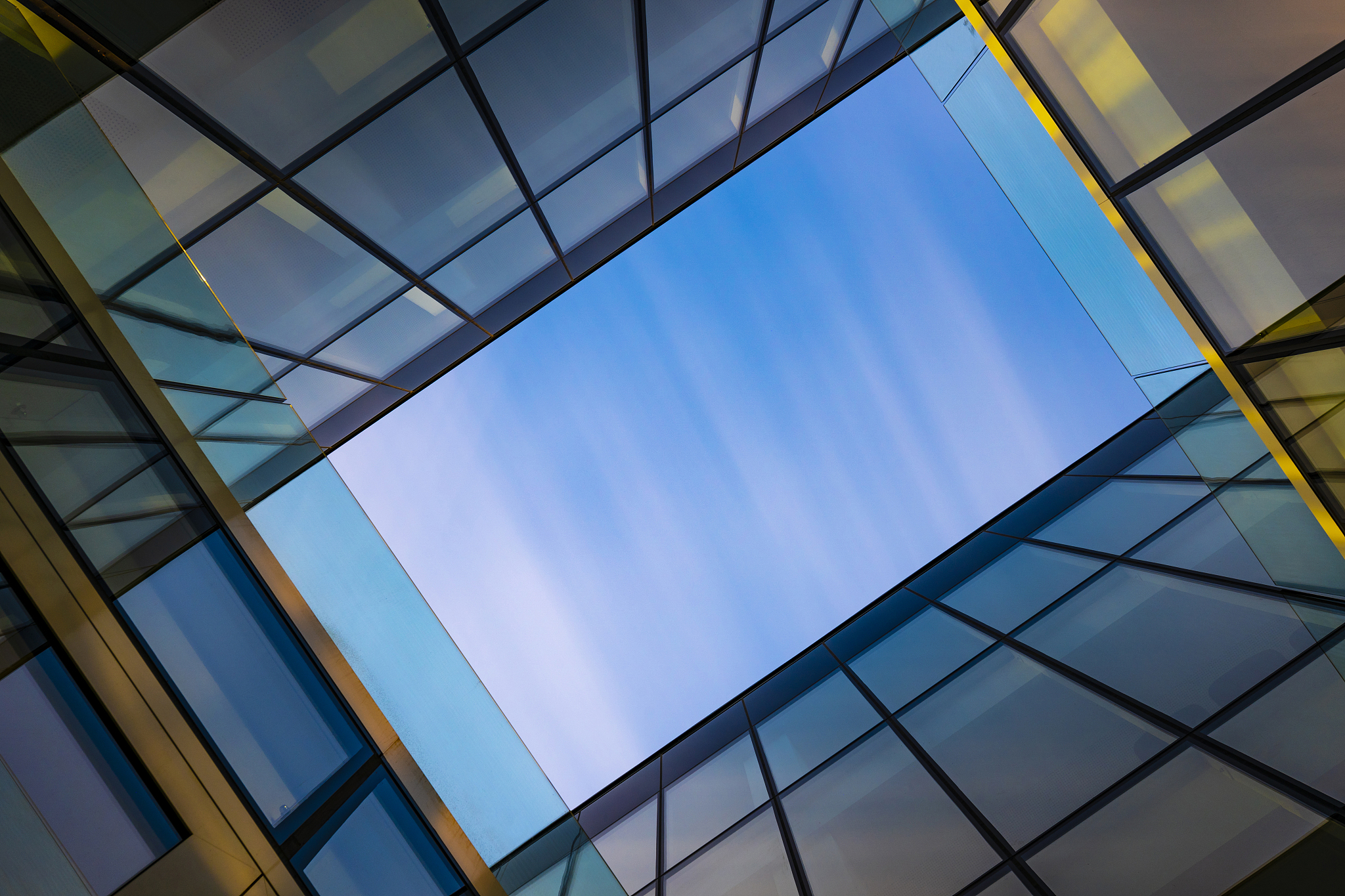 low angle view of glass building against sky