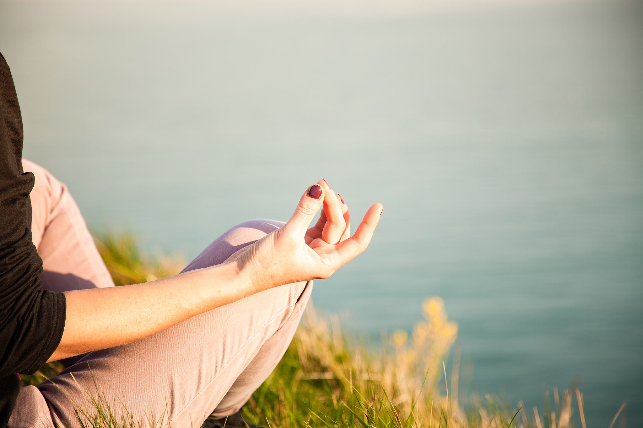 woman doing yoga in beautiful nature background at sunset or sun