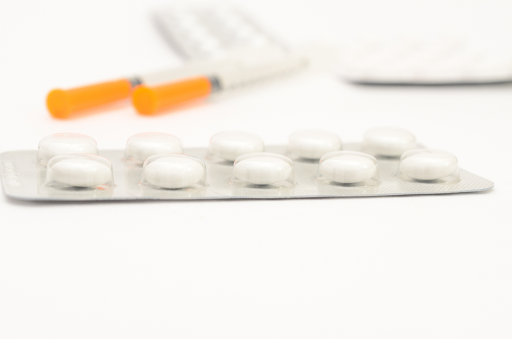 contraceptive tablets in packages and without on a light backgro