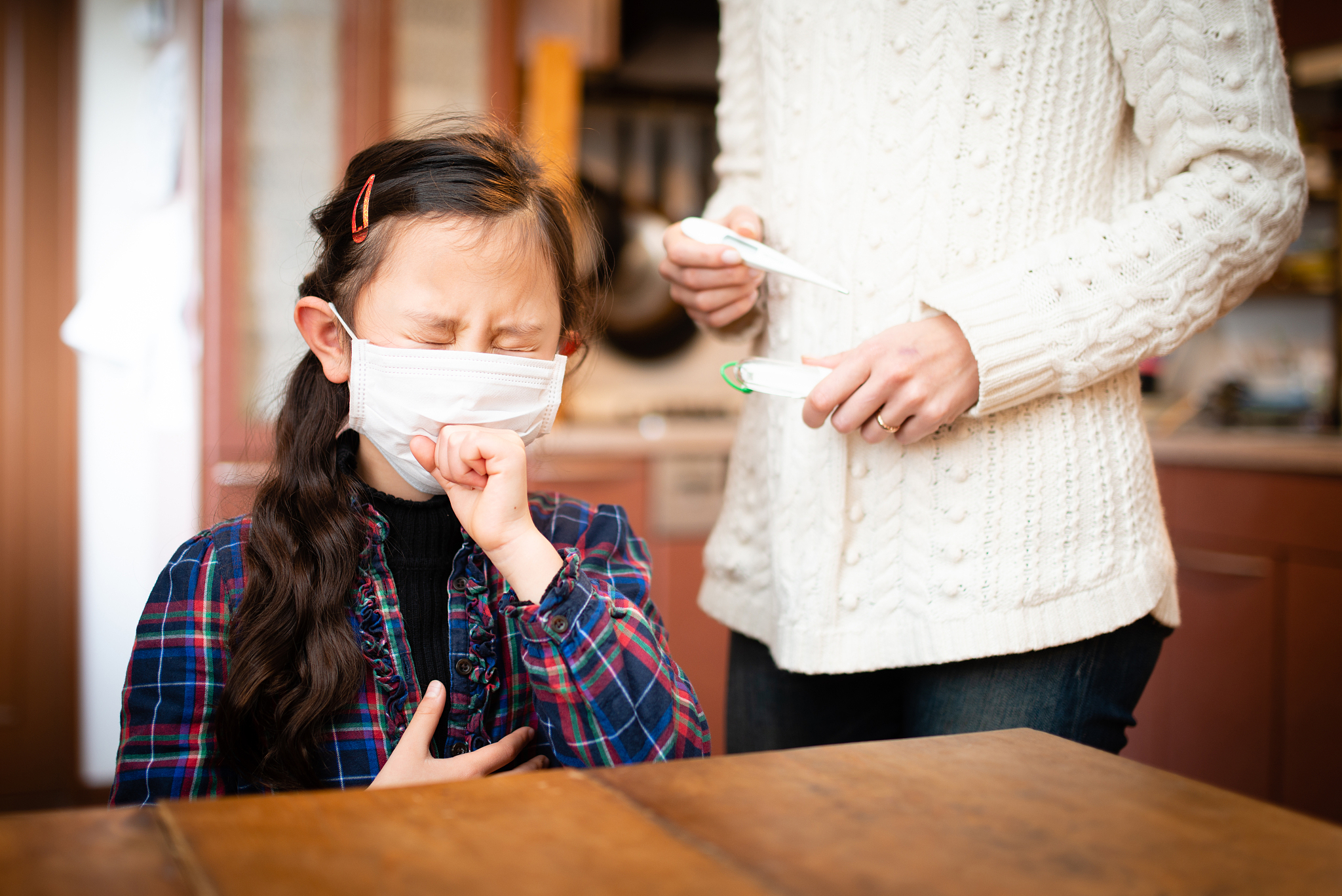 daughter coughing and mother worried