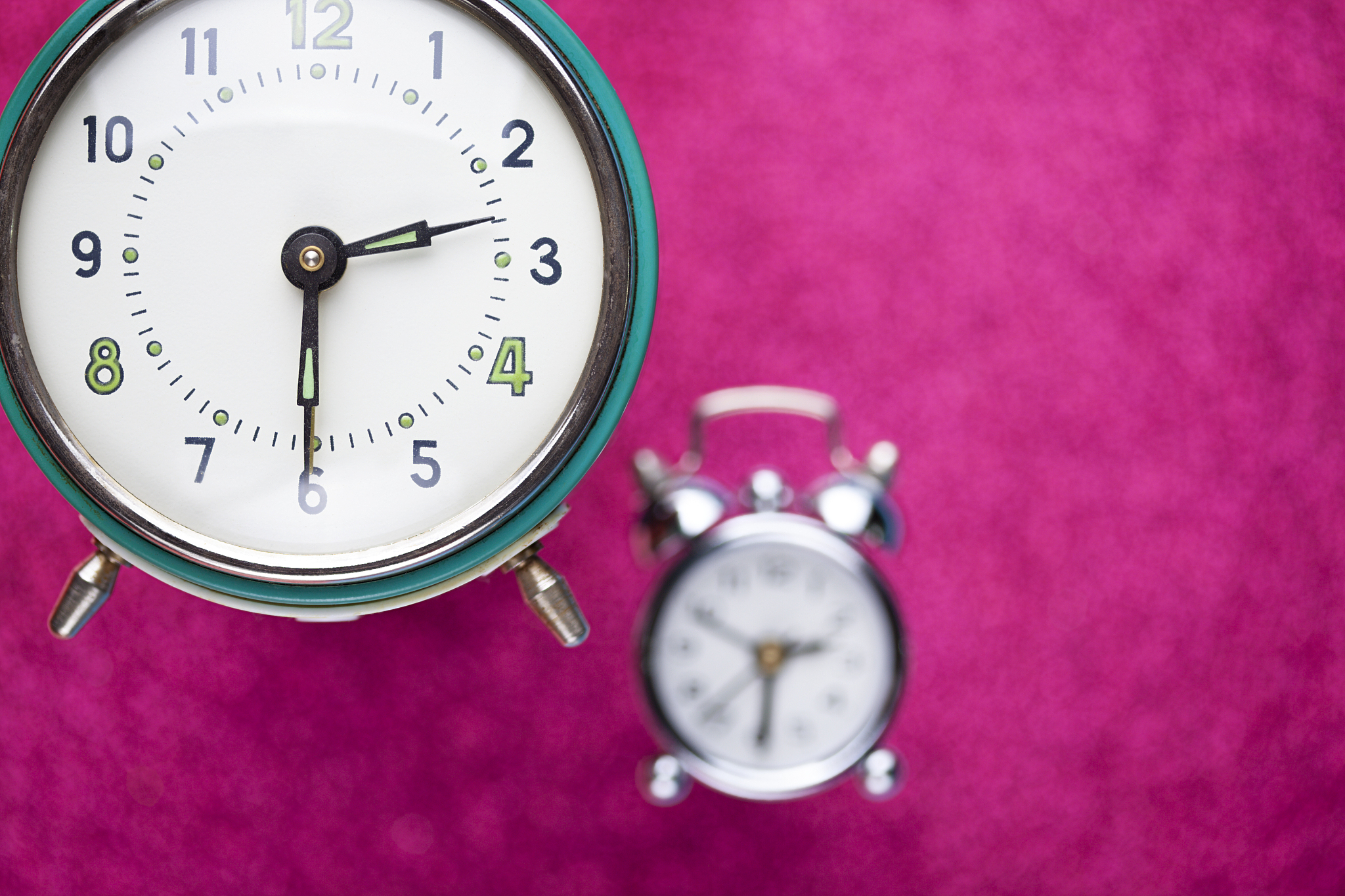 retro alarm clock on pink abstract background